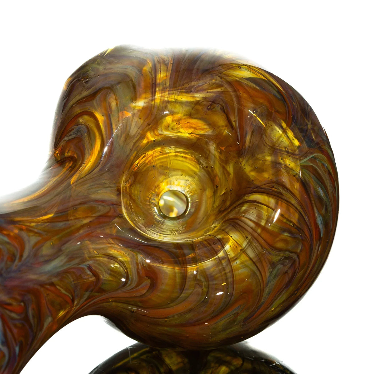 Close-up of orange and yellow glass spoon pipe with marbled swirls and glossy finish