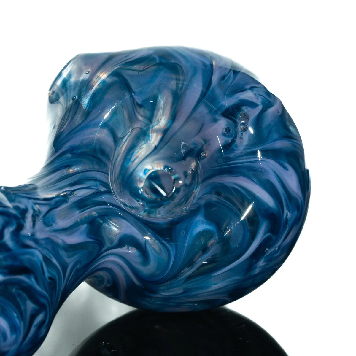 Close-up of a blue and purple swirl glass spoon pipe with hourglass shape