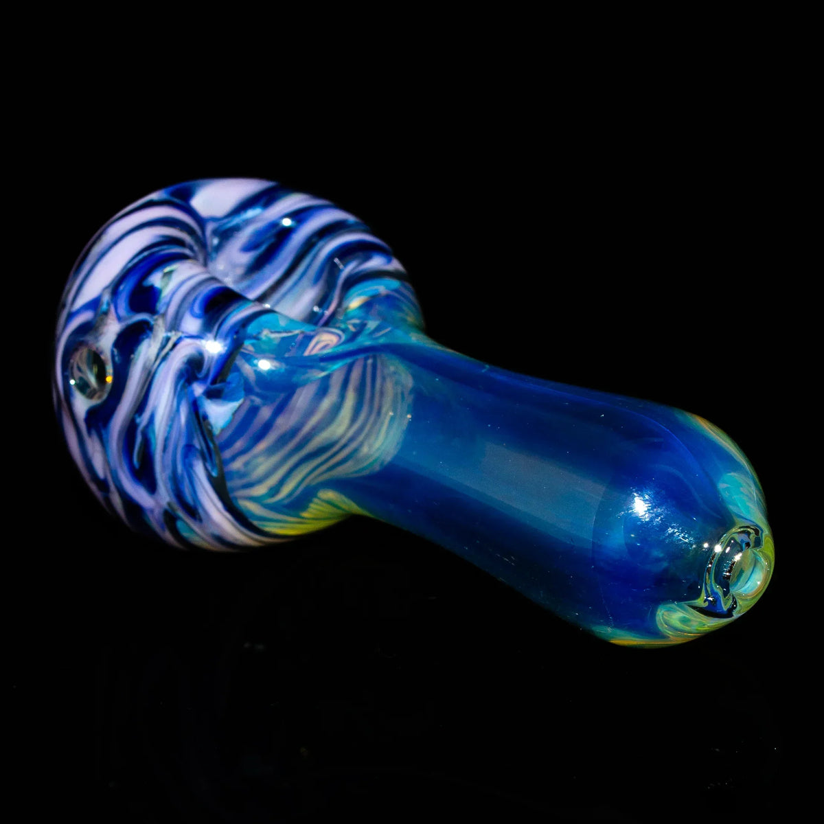 Purple and pink fumed glass spoon pipe with swirling patterns against black background