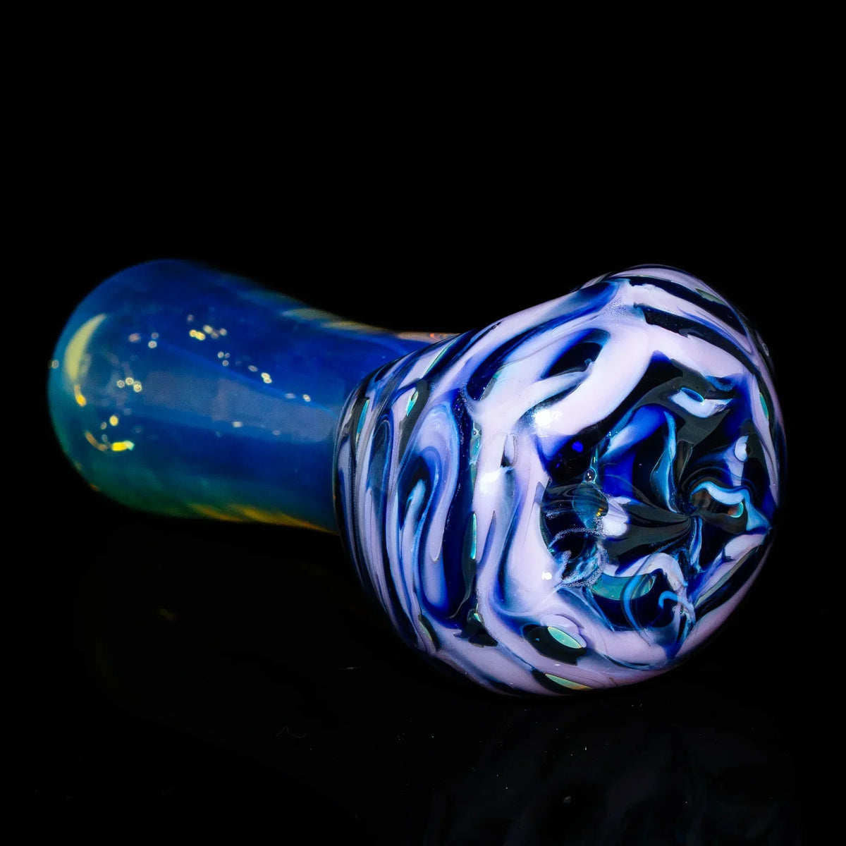 Purple and pink glass hand pipe with swirling patterns on black background