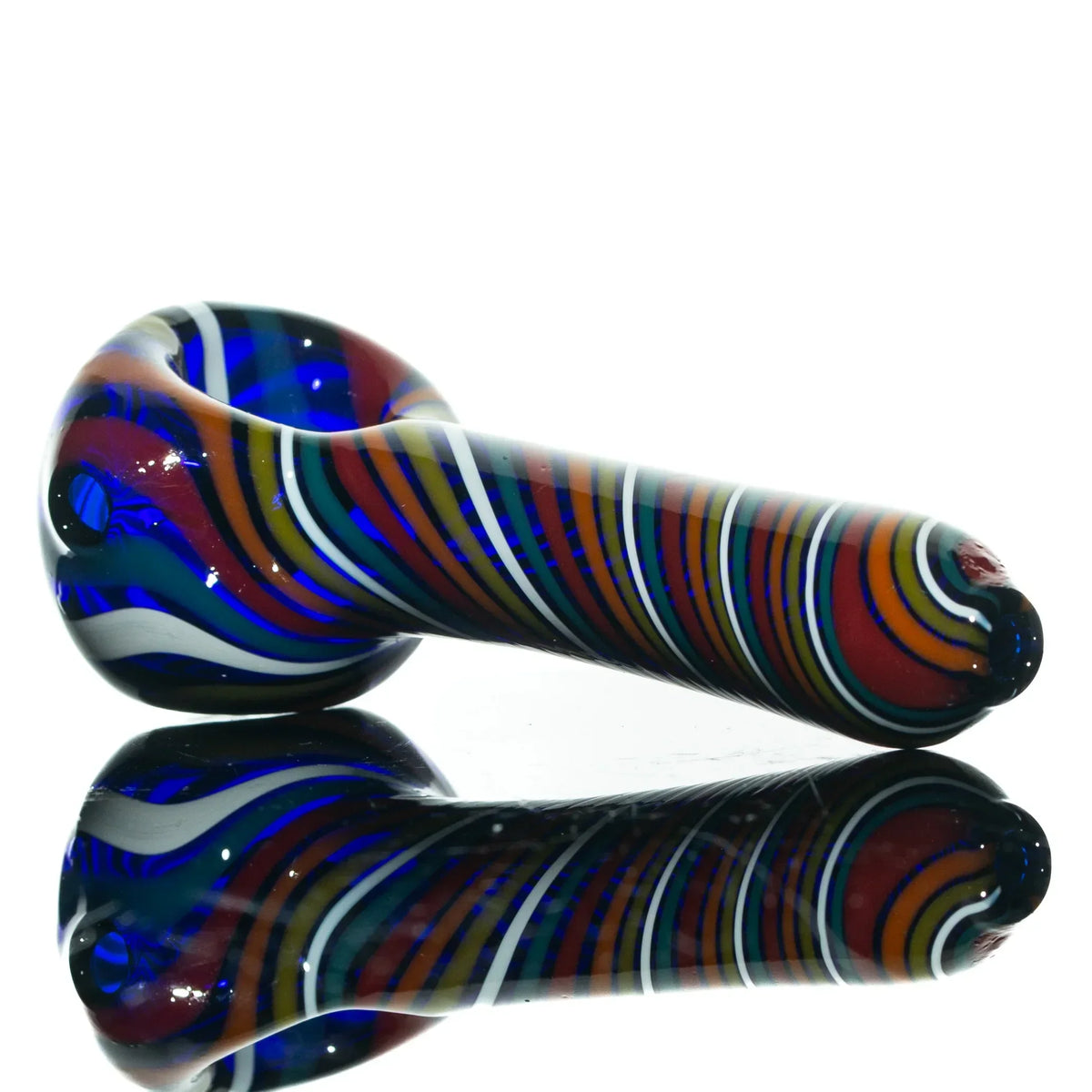 Colorful hand-blown glass smoking pipe with swirling rainbow stripes on a reflective surface