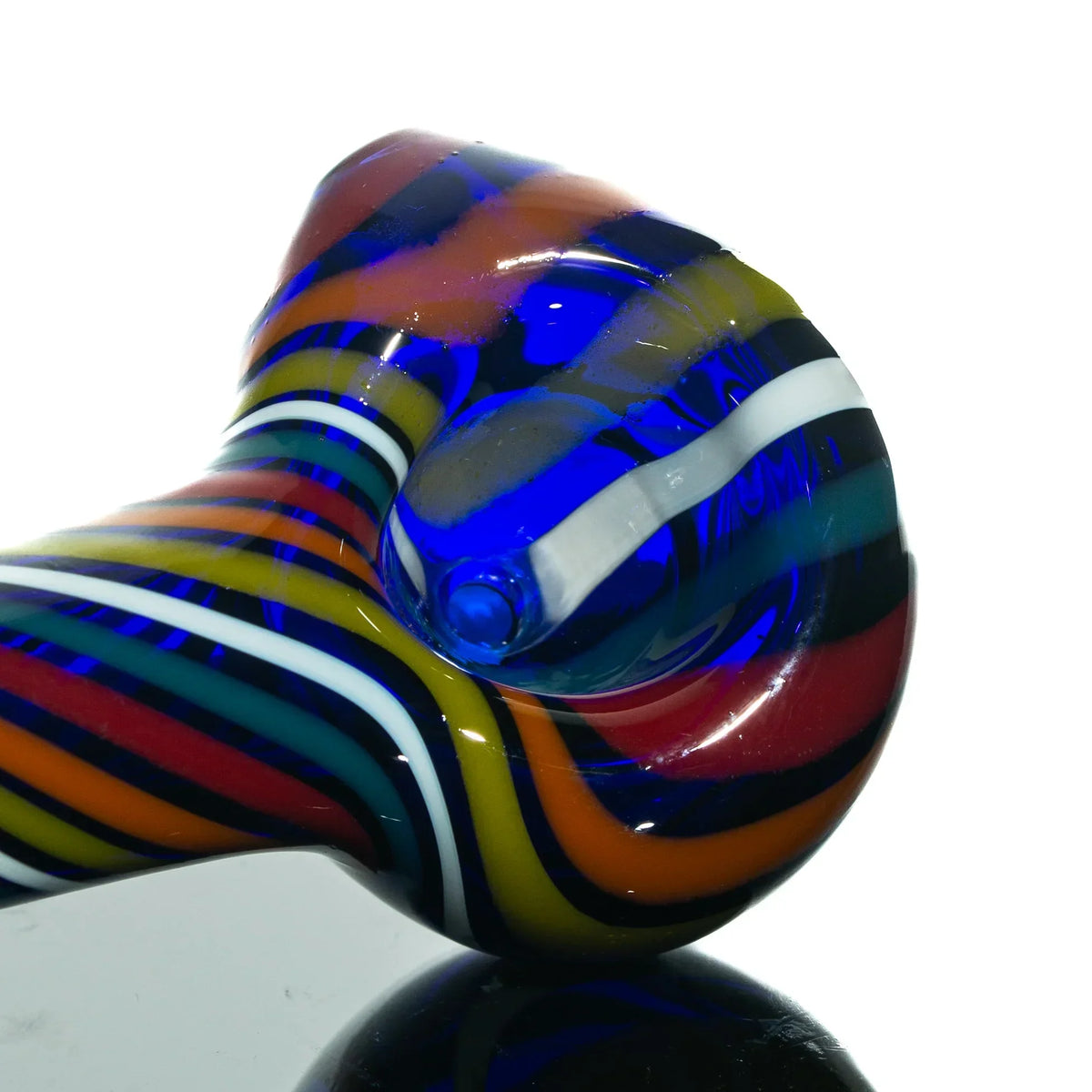 Close-up of a colorful rainbow twist glass hand pipe with vibrant swirling stripes