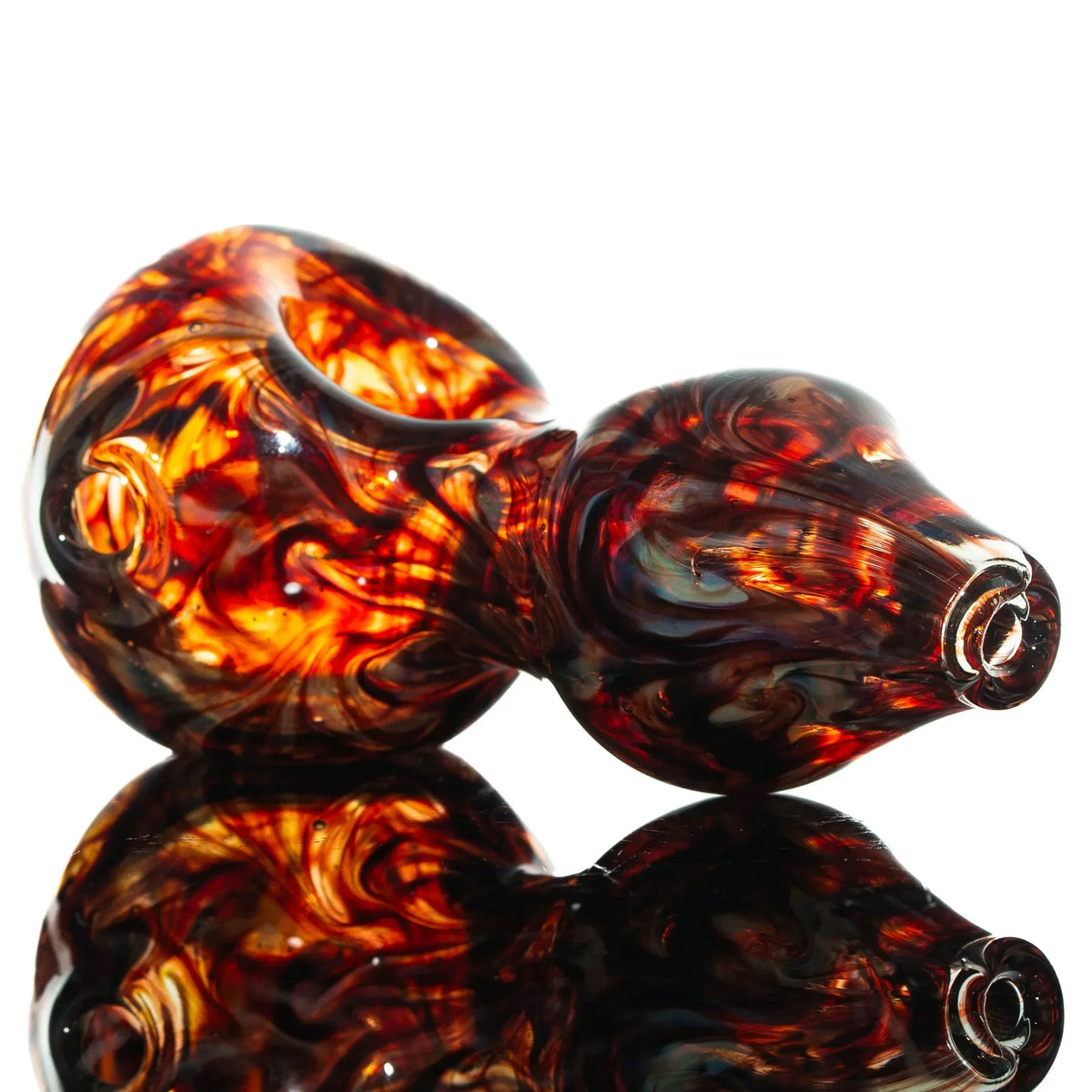 Red slyme glass spoon pipe with raked hourglass design on reflective surface