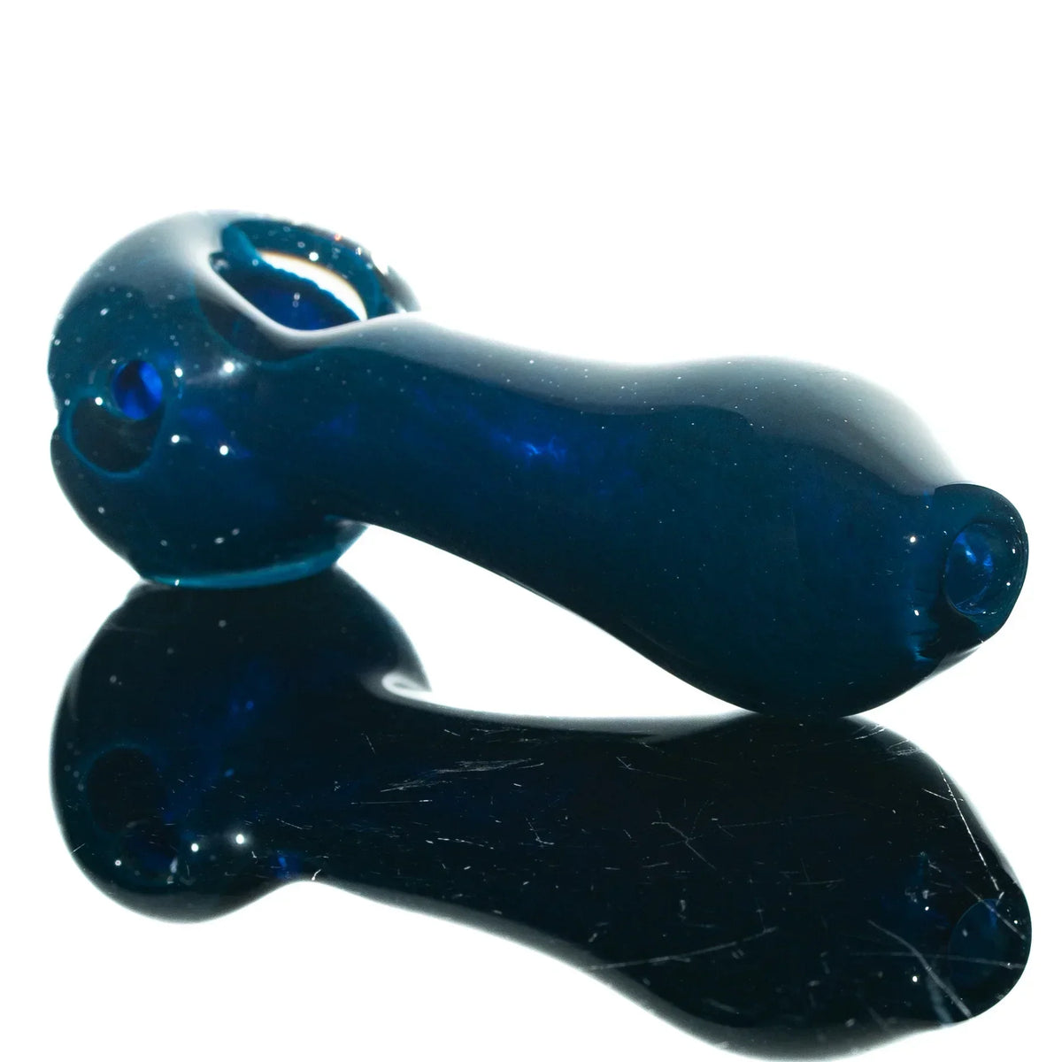 Blue glass hand pipe with a smooth, reflective surface and ergonomic spoon shape.