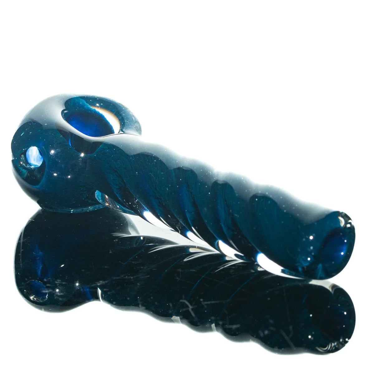 Blue glass hand pipe with twisted frit design on a reflective surface