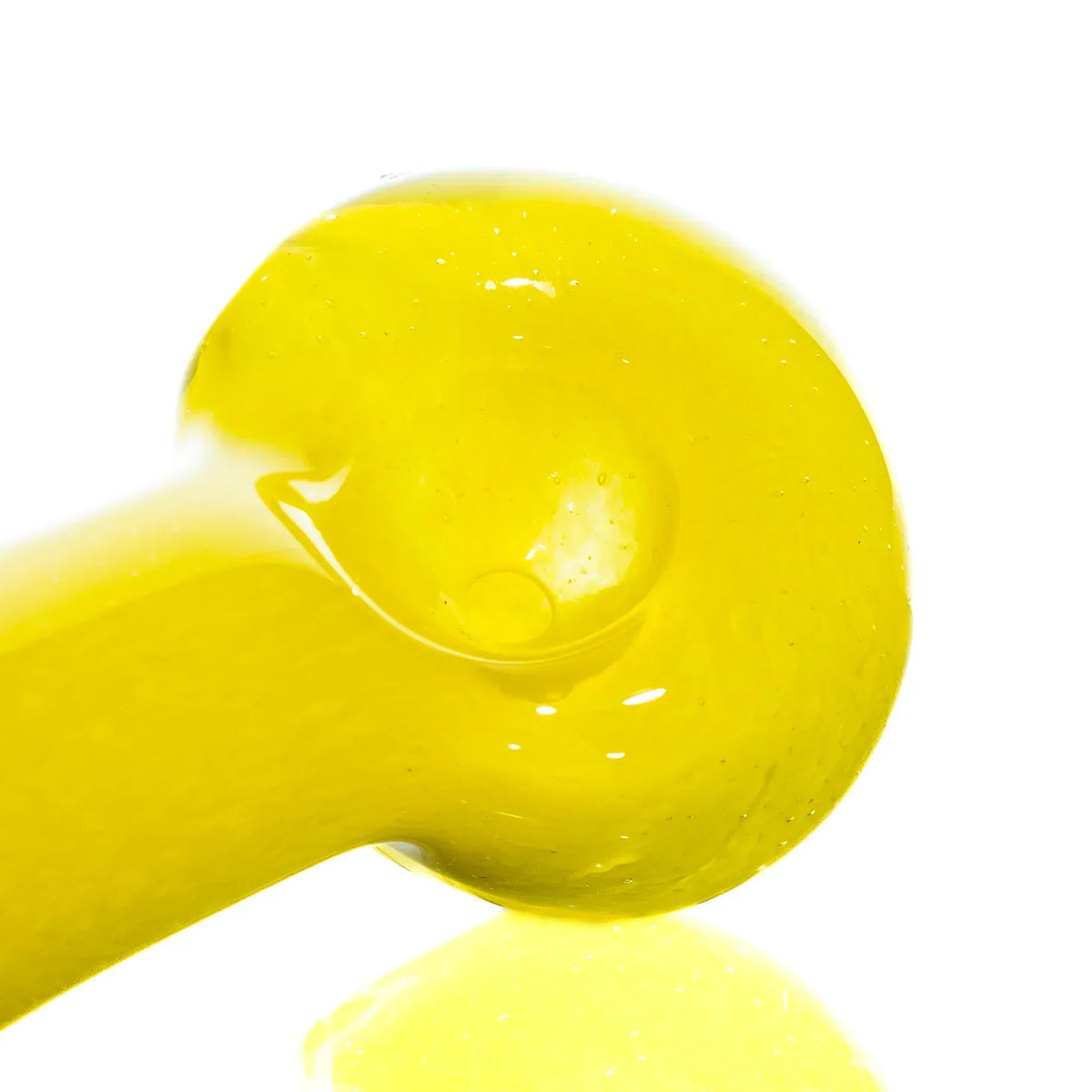 Close-up of a yellow glass hand pipe with a smooth, glossy finish on a white background