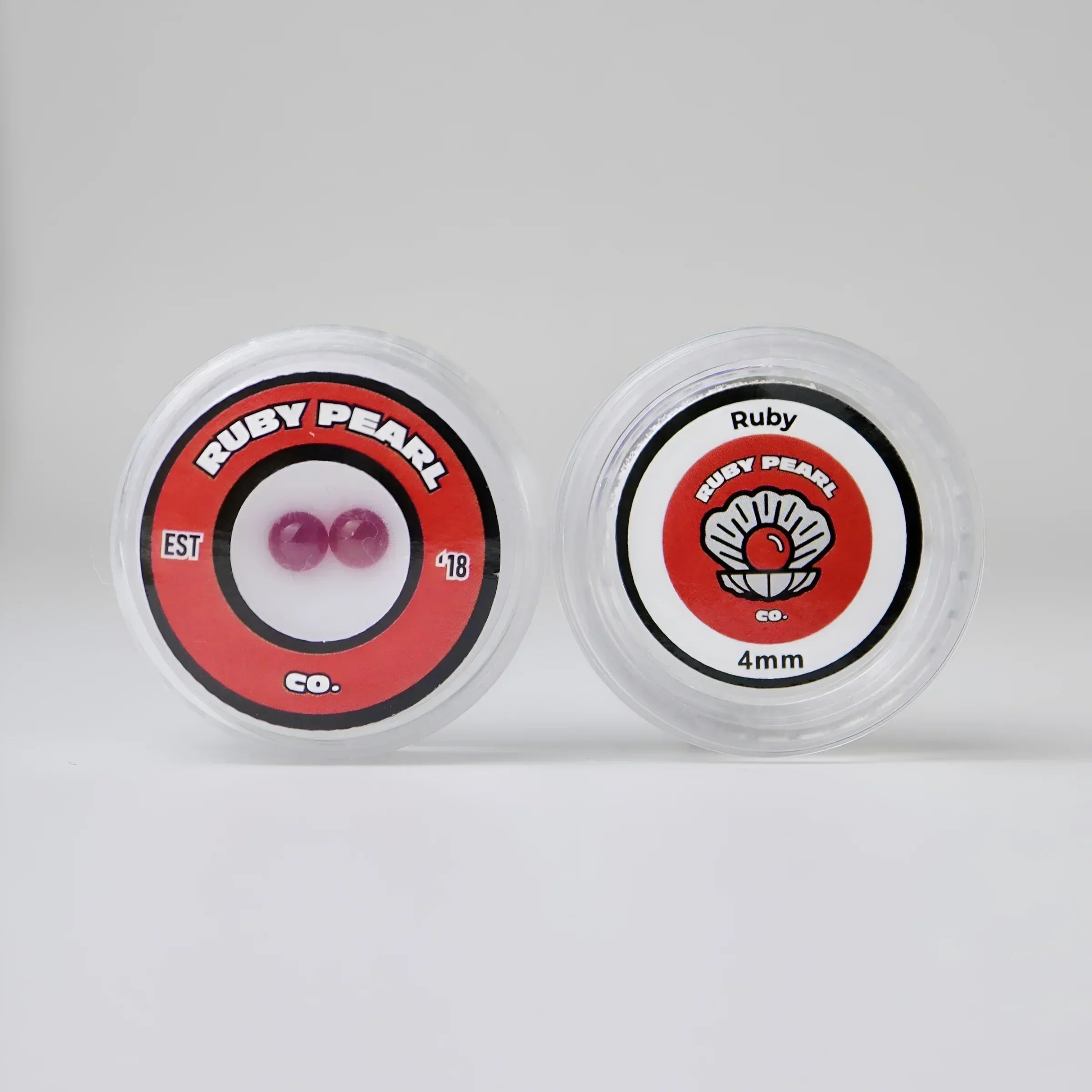Ruby Pearl Co. 4mm ruby terp pearls in round display containers on a white background