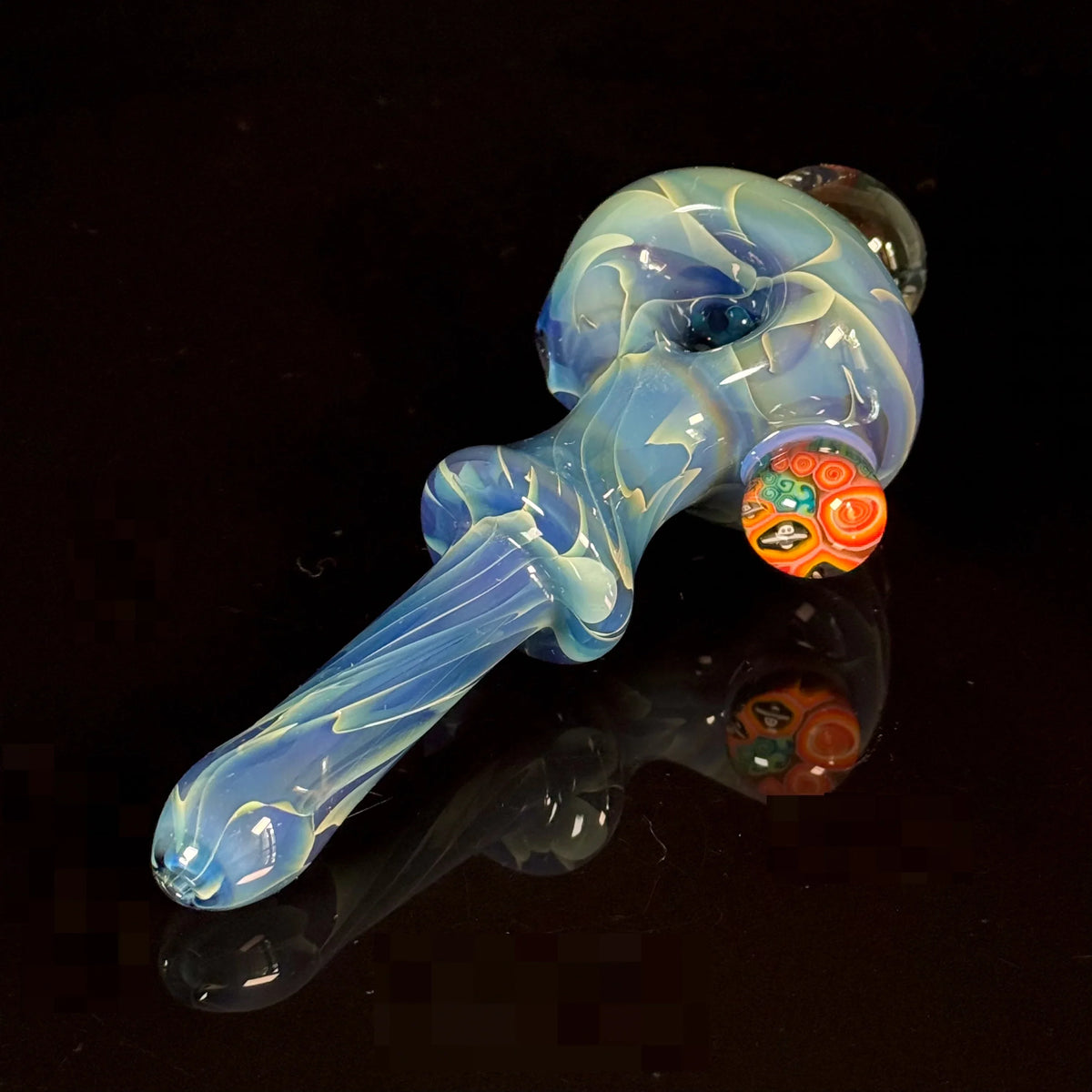 Blue hand-blown glass pipe with colorful marble accent on a black background