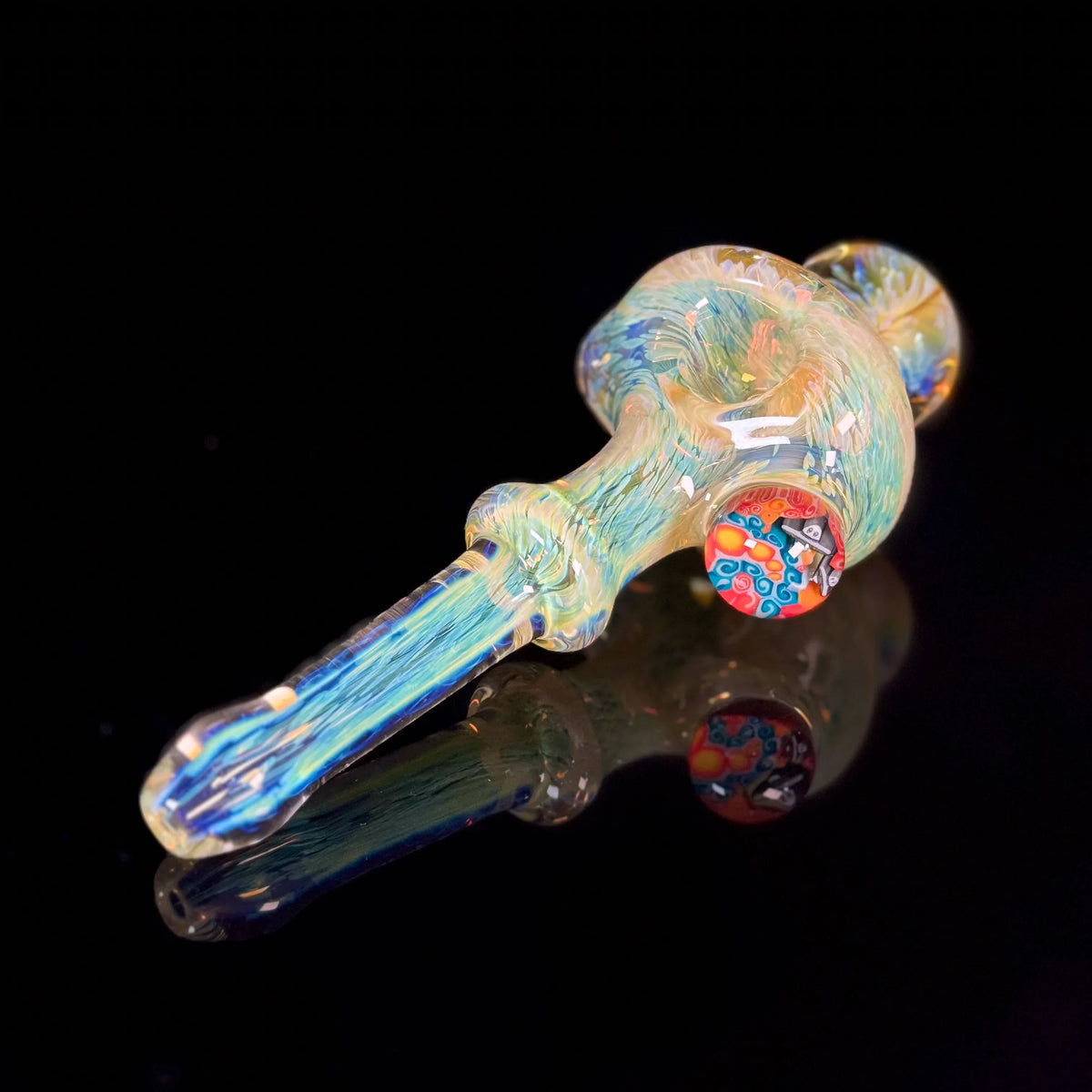 Handcrafted glass pipe with colorful swirl patterns on a black background