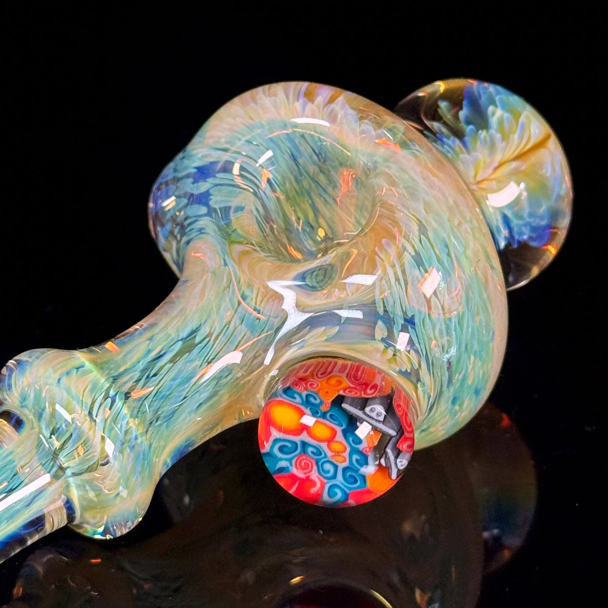 Colorful hand-blown glass pipe with intricate swirl patterns and a vibrant accent marble