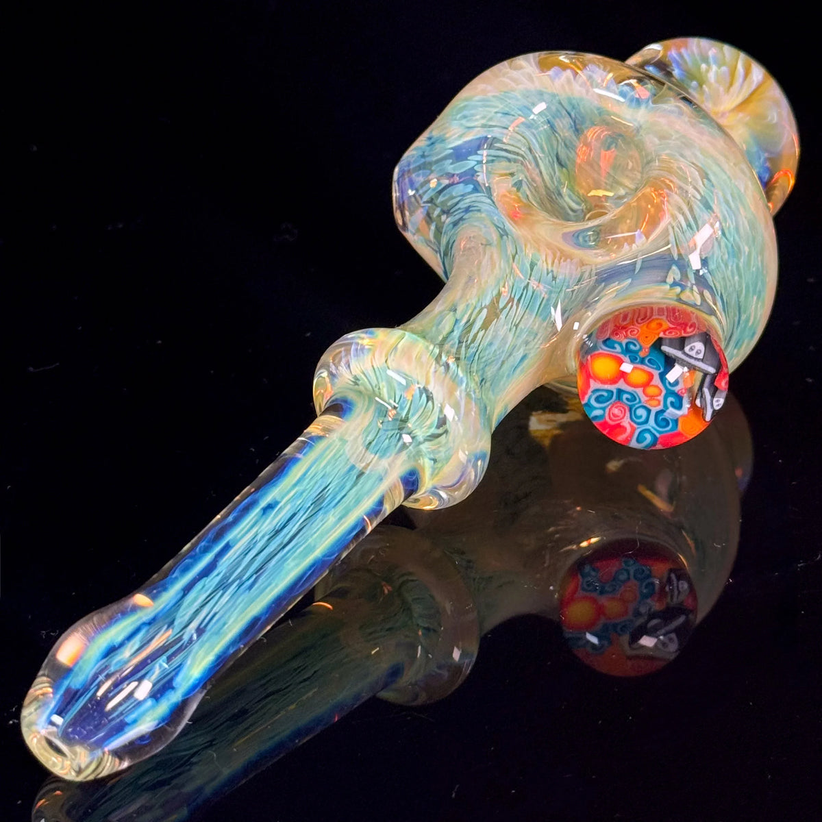 Handcrafted glass pipe with vibrant blue and yellow swirls and decorative accent, on black background
