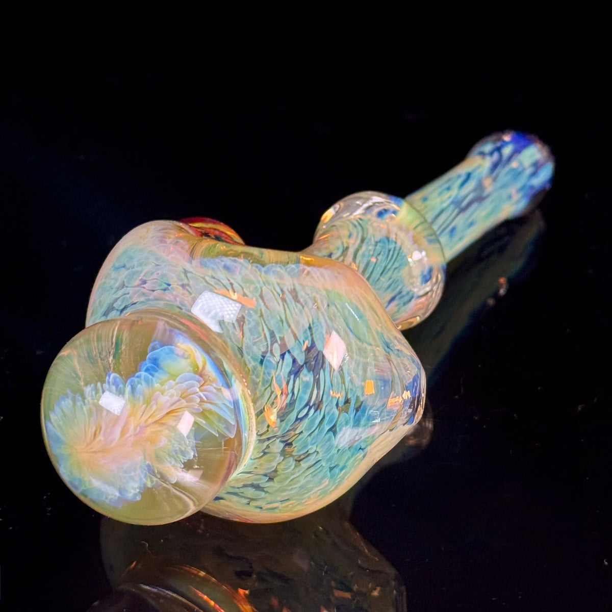 Hand-blown glass pipe with iridescent, multicolor swirling patterns on black background