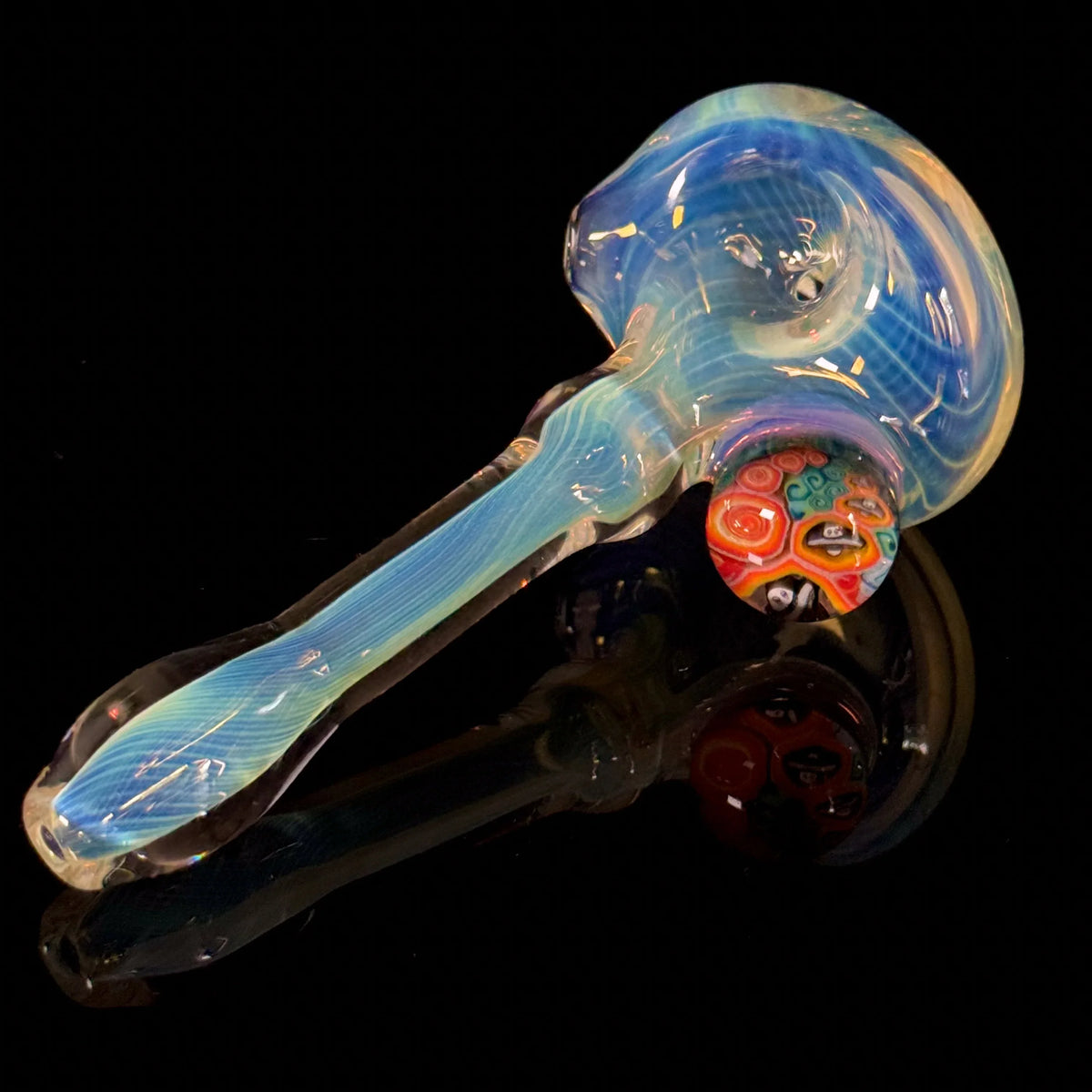 Colorful glass hand pipe with swirling blue patterns and vibrant accent on black background