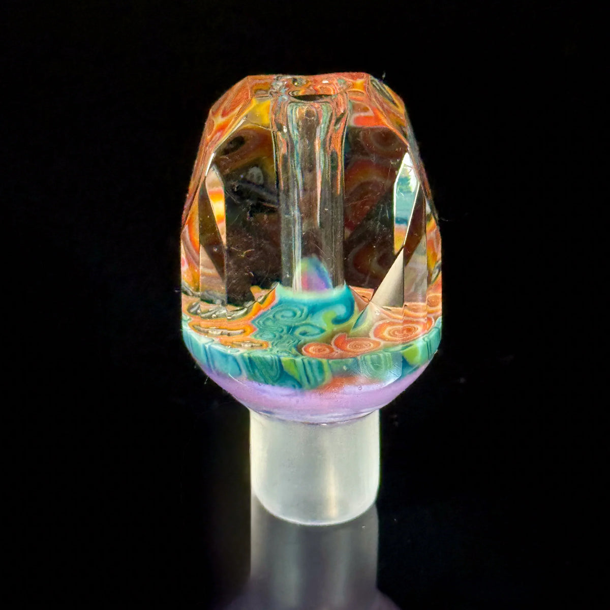 Colorful handcrafted glass carb cap with intricate patterns on a black background