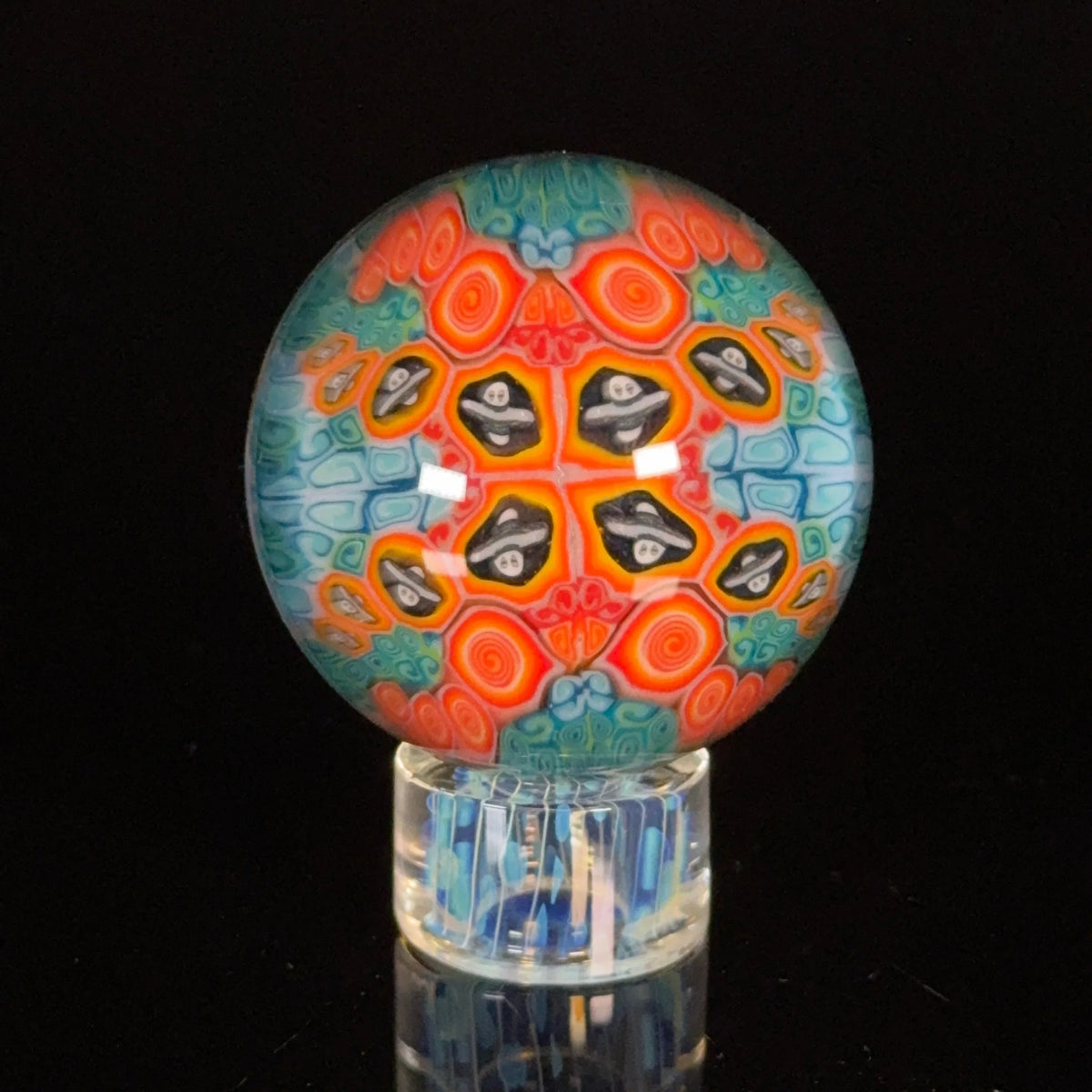 Colorful heady glass marble with intricate swirling patterns and skull designs
