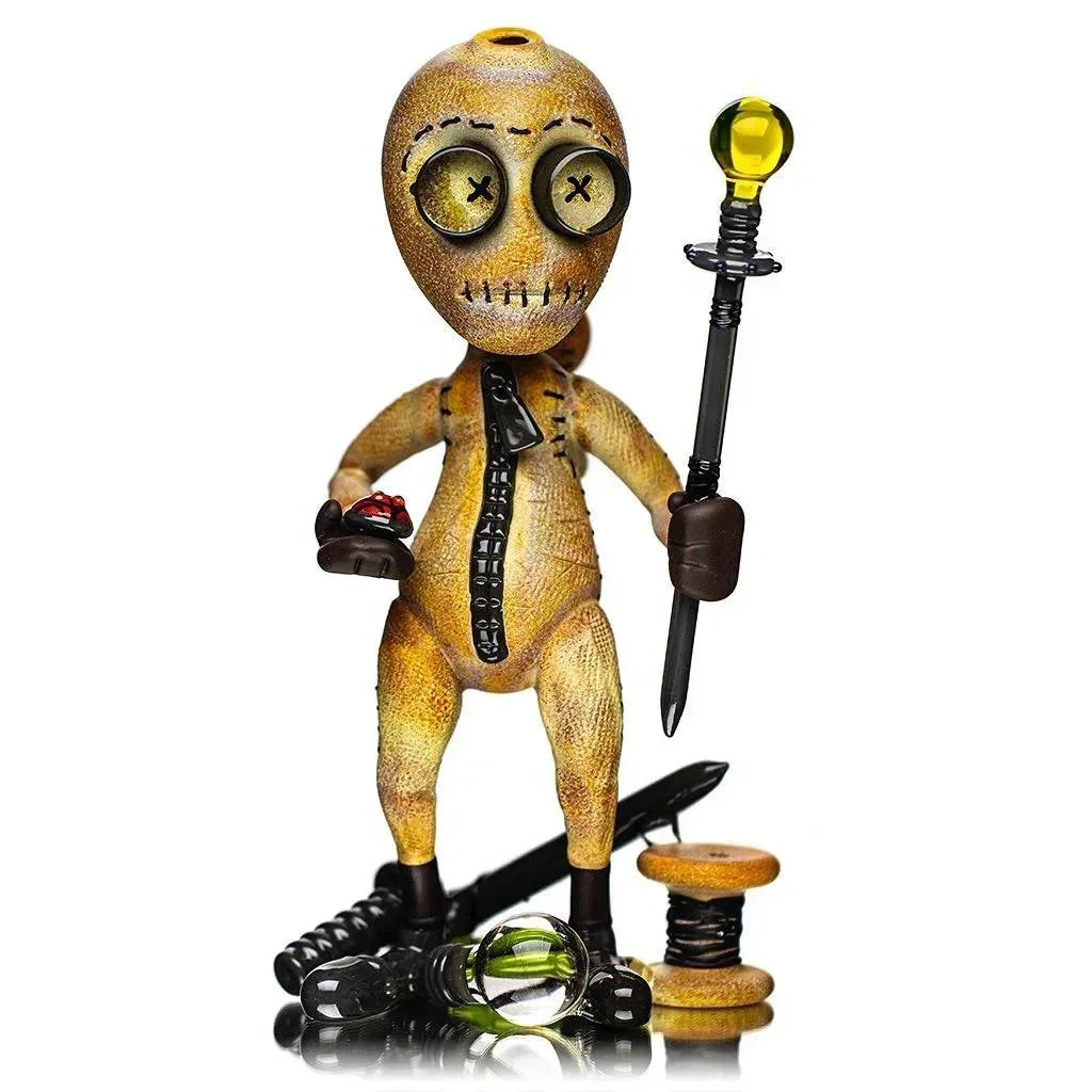 Handcrafted glass voodoo doll water pipe with button eyes, zipper details, and sculpted accessories.
