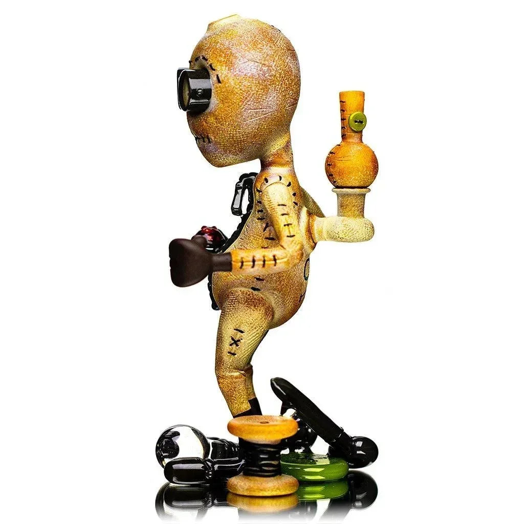 Artistic glass figurine pipe shaped like a stitched doll with goggles, unique heady glass design