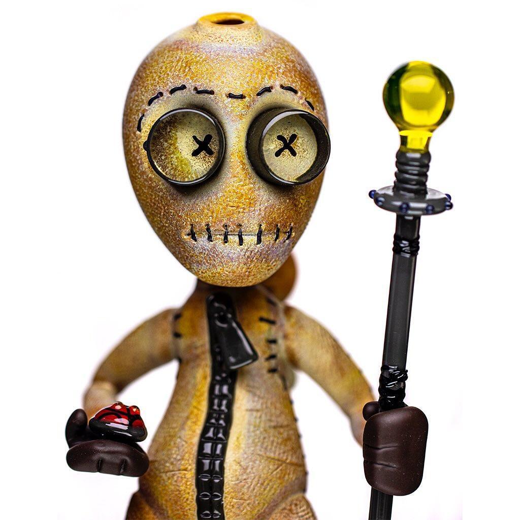Handcrafted glass art figure with stitched details and yellow orb staff, collectible piece