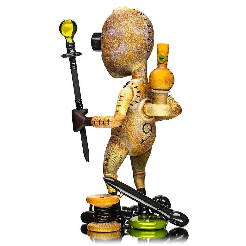 Handcrafted glass figure with stitched doll design holding glass accessories, art collectible