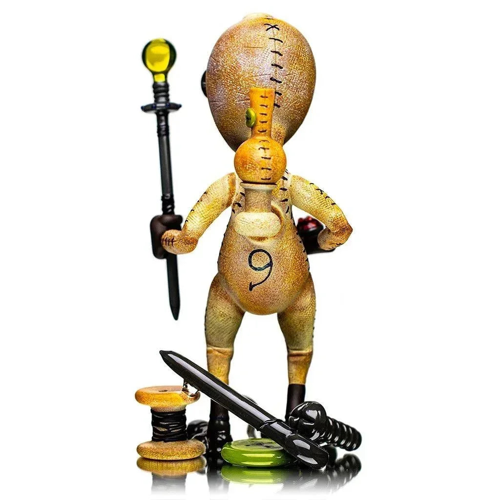 Handcrafted glass art figurine resembling a stitched doll with accessories, pipe gallery style