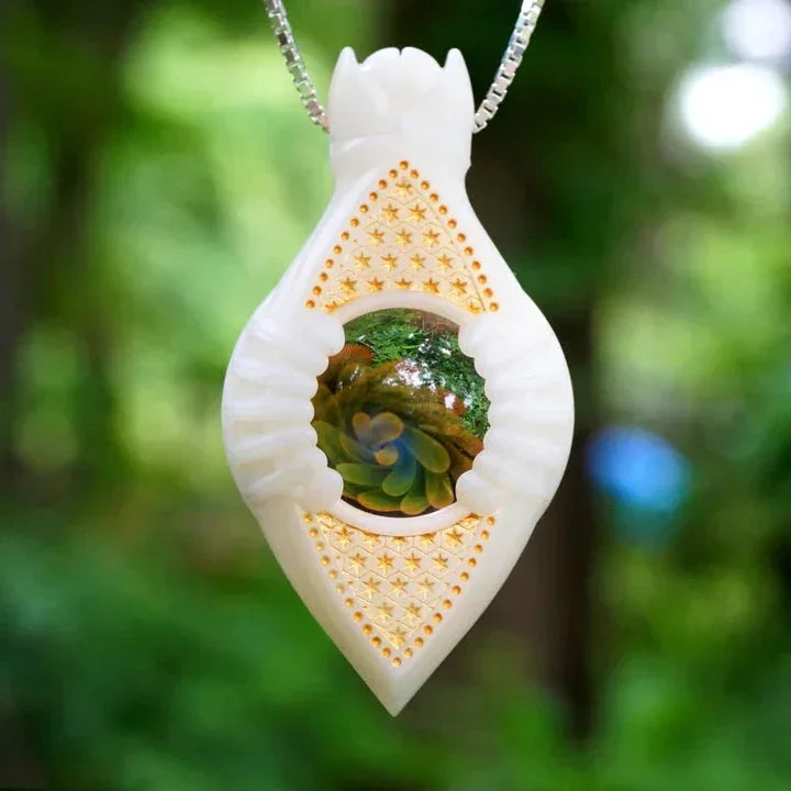 White glass pendant necklace with gold star details and colorful glass marble center