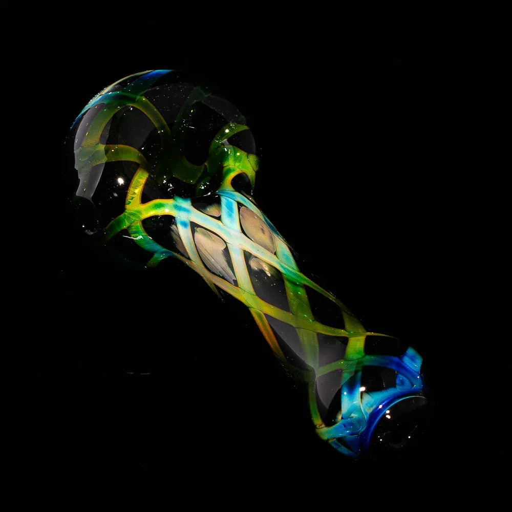 Hand-blown glass spoon pipe with black crosshatch design and vibrant green and blue accents