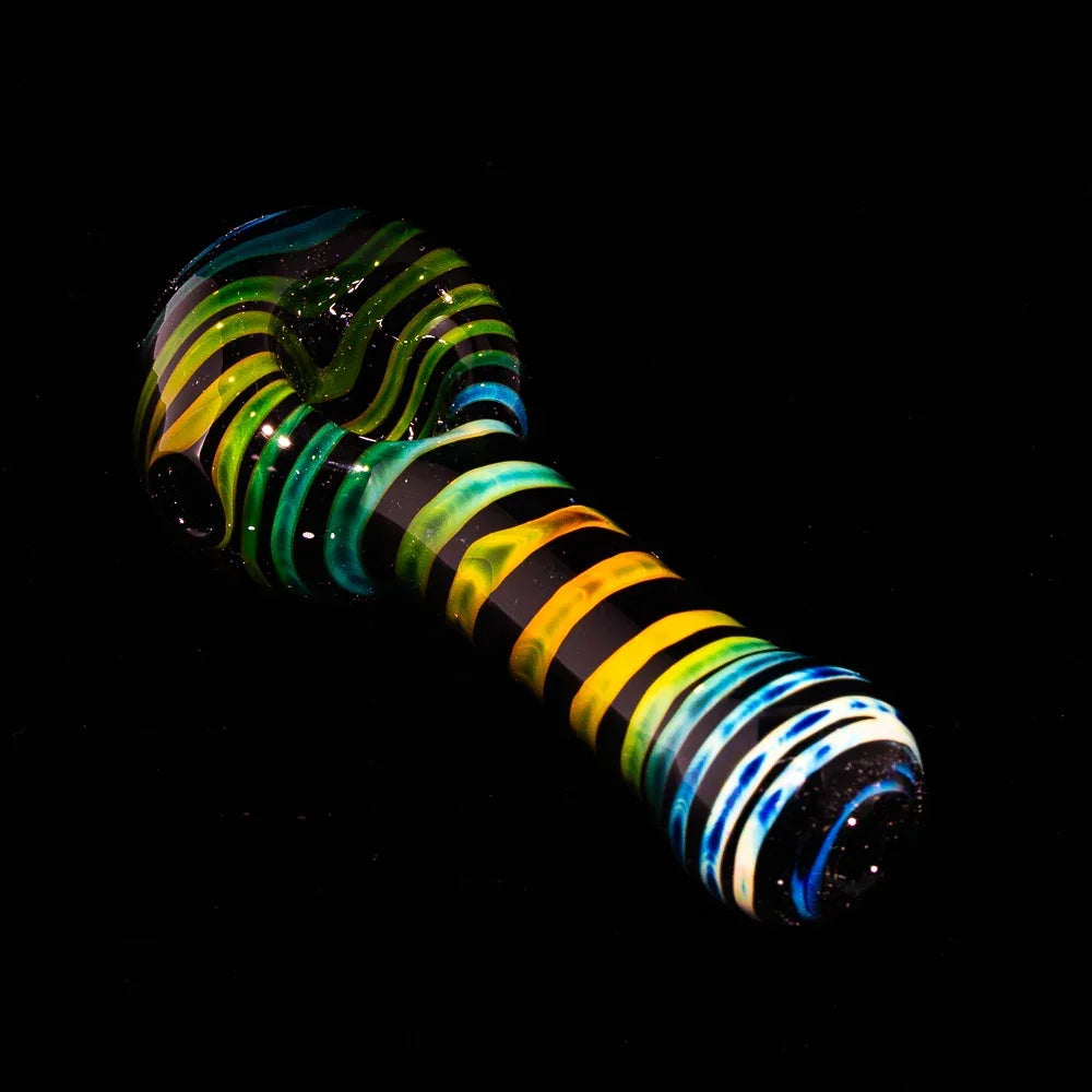 Black fumed glass hand pipe with vibrant yellow, blue, and green coil patterns