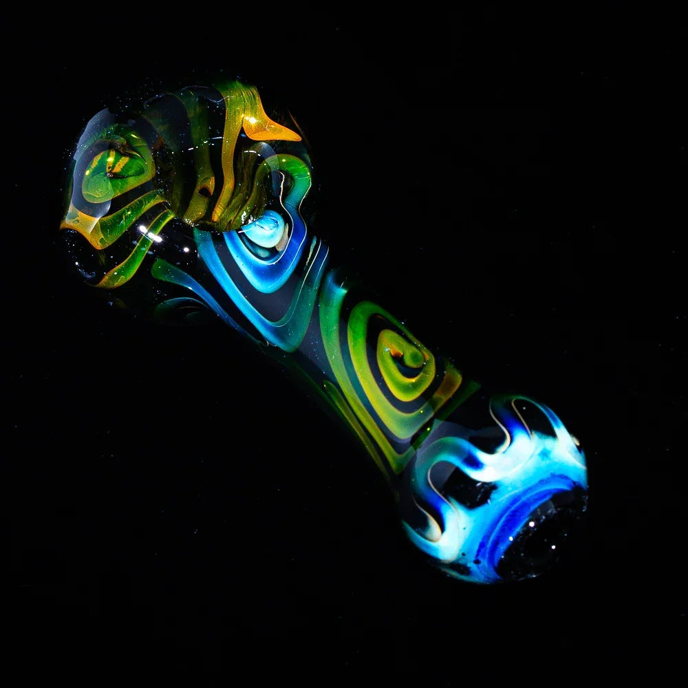colorful glass hand pipe with black spiral and swirl patterns on a black background