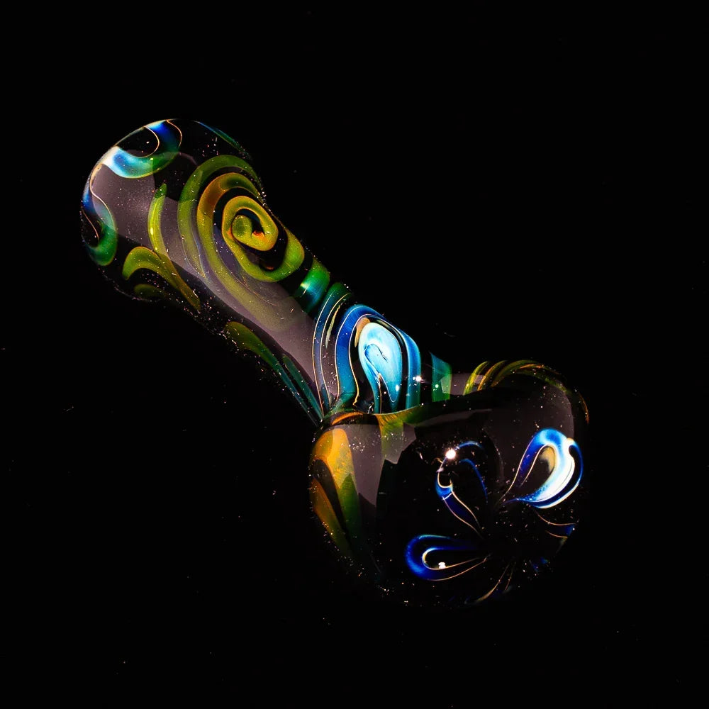 Colorful hand-blown black glass spoon pipe with vivid spiral and flower design