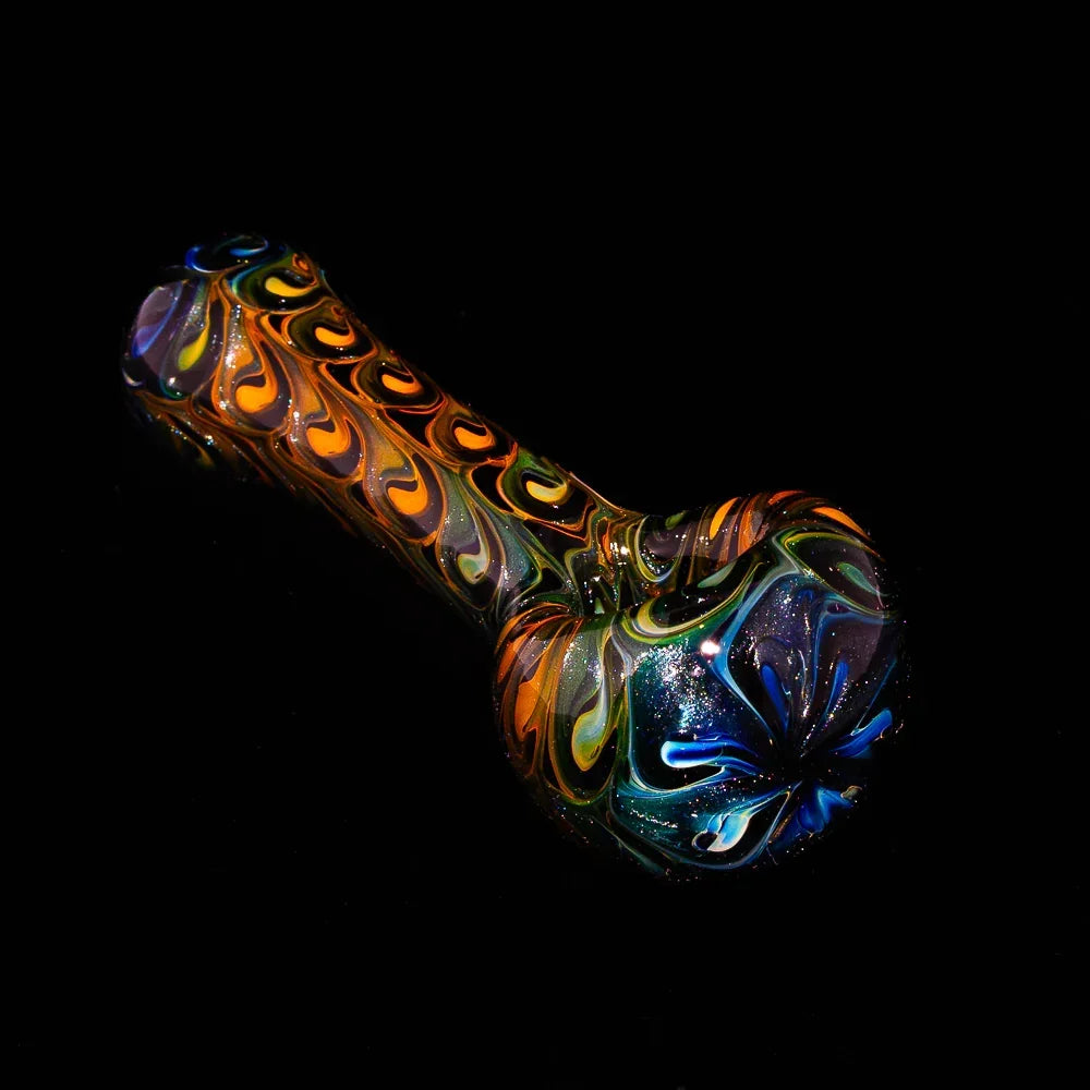Hand-blown glass spoon pipe with vibrant peacock-inspired swirl design on black background.