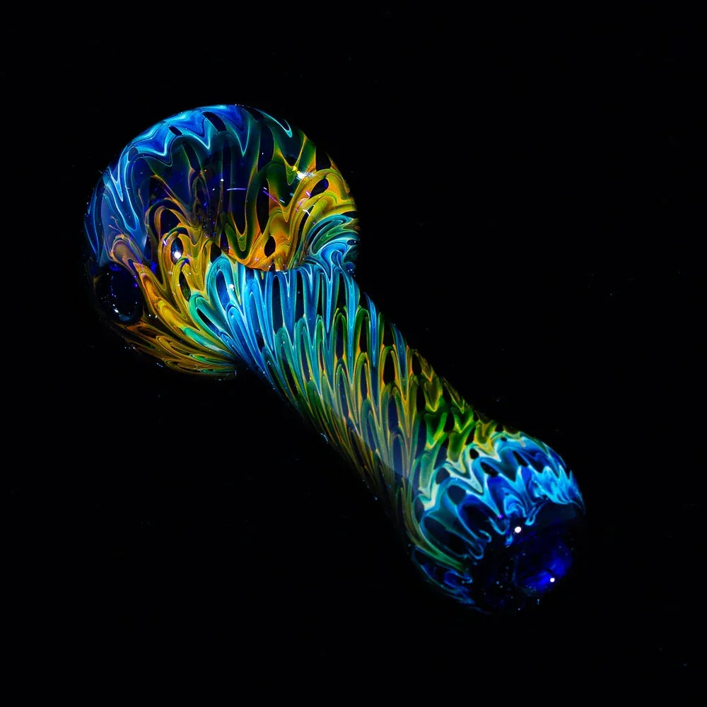 Blue and yellow raked glass hand pipe with fume detail on a black background