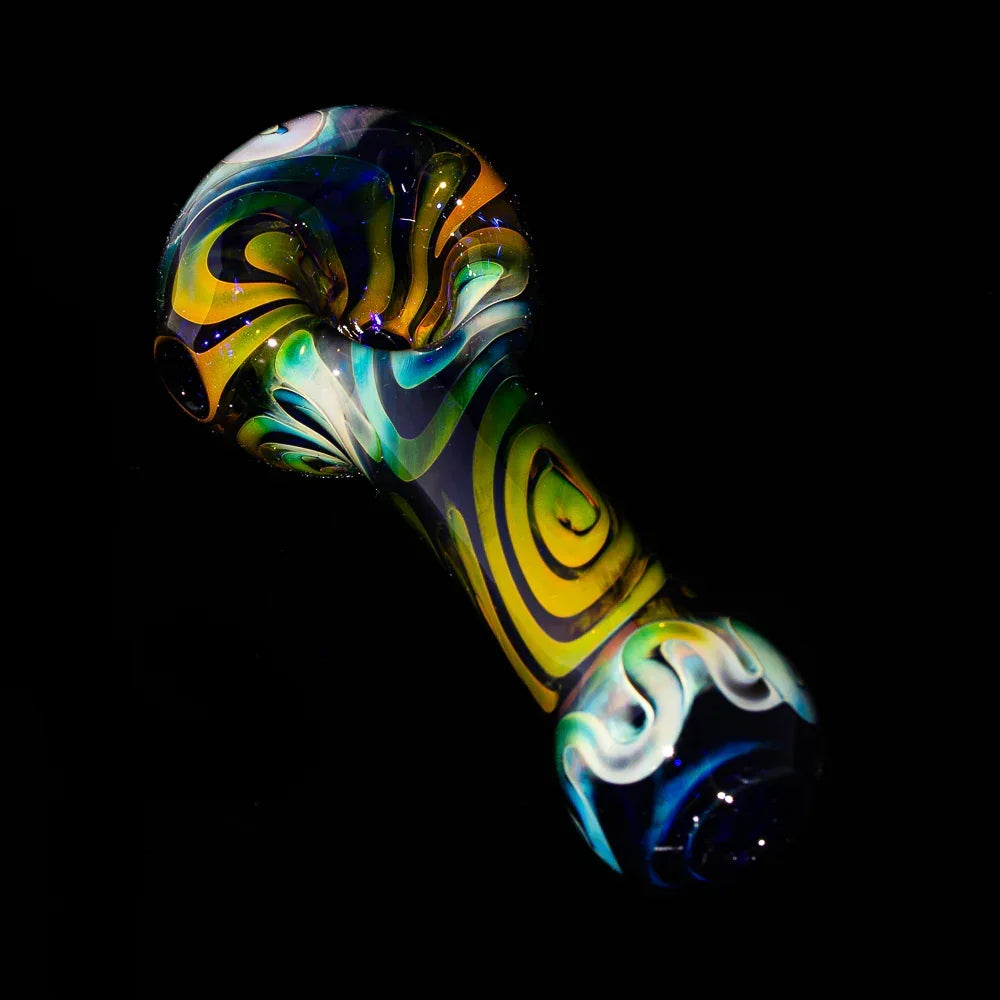 Hand-blown glass spoon pipe with vibrant blue and yellow spiral design on black background