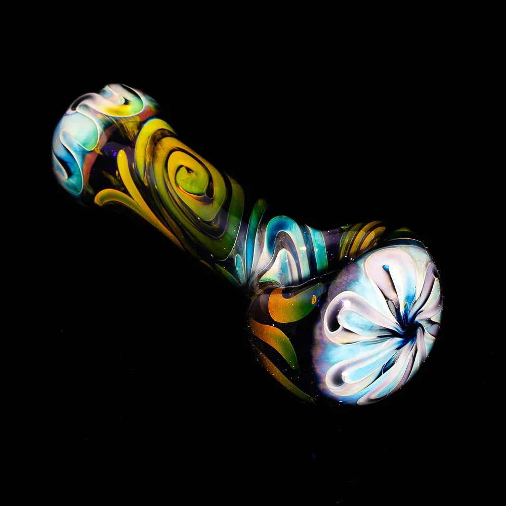 Colorful glass hand pipe with blue spiral and swirl patterns on a black background