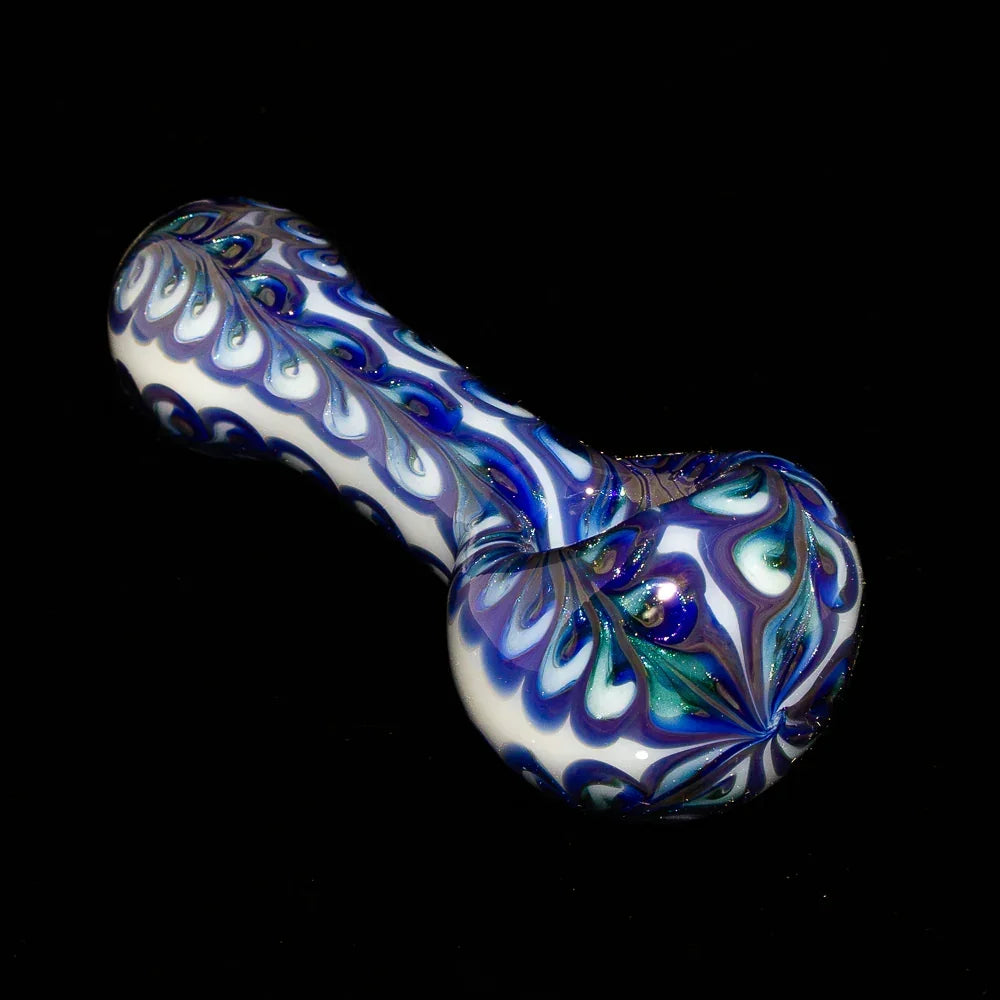 Blue and white paisley glass hand pipe with intricate patterns on a black background
