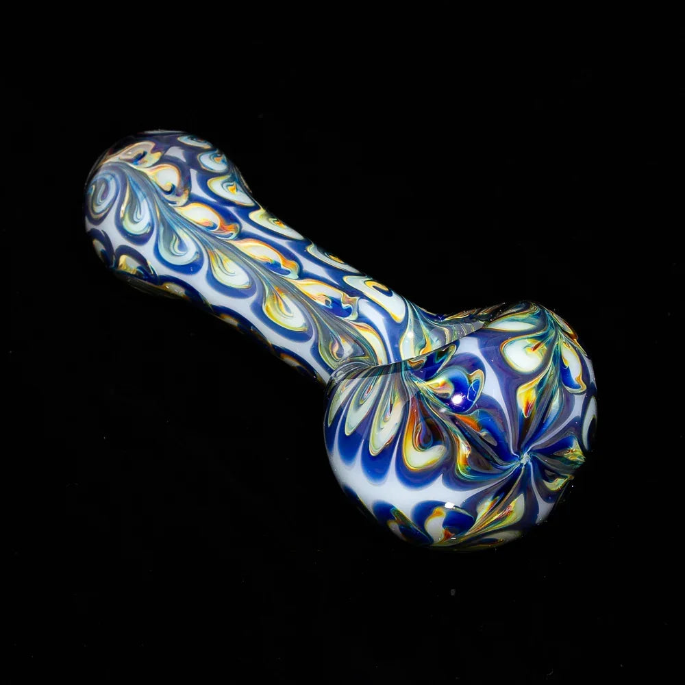 Blue and yellow paisley glass hand pipe with intricate swirl design on a black background