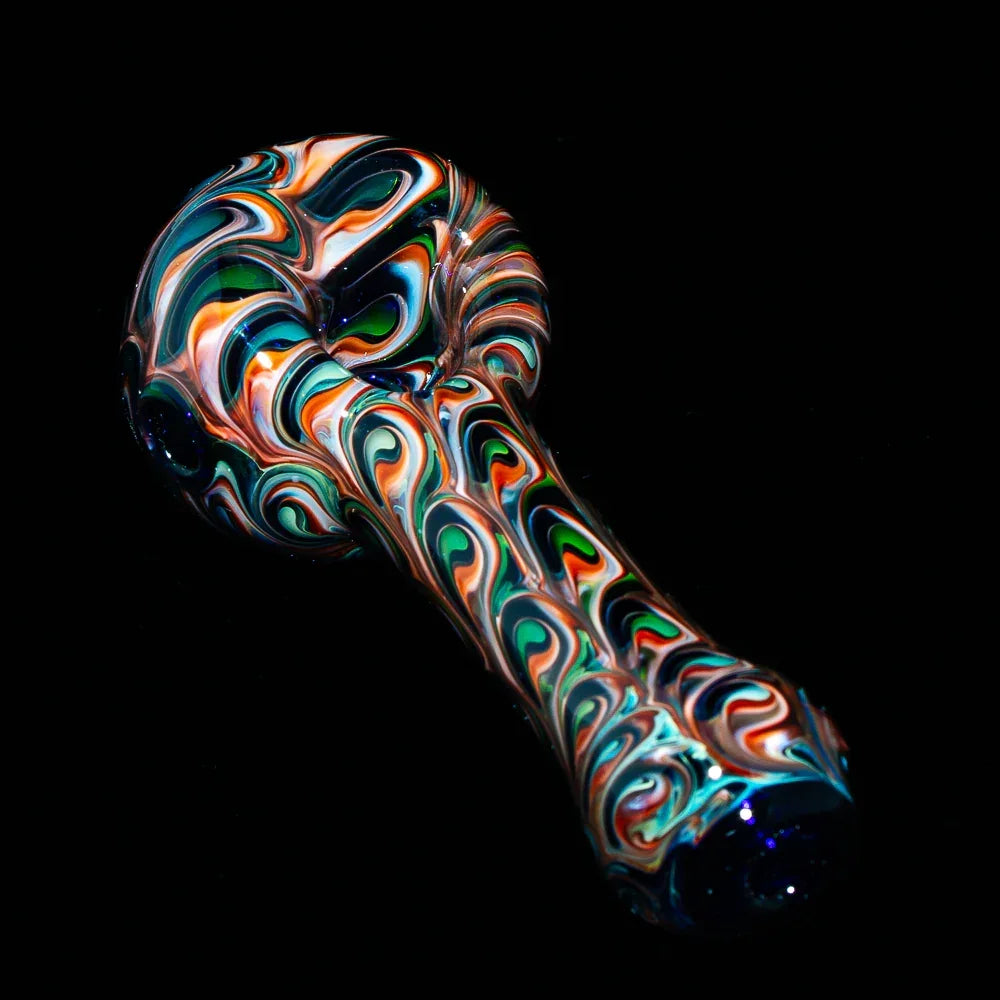Colorful hand-blown glass spoon pipe with peacock swirl pattern on black background