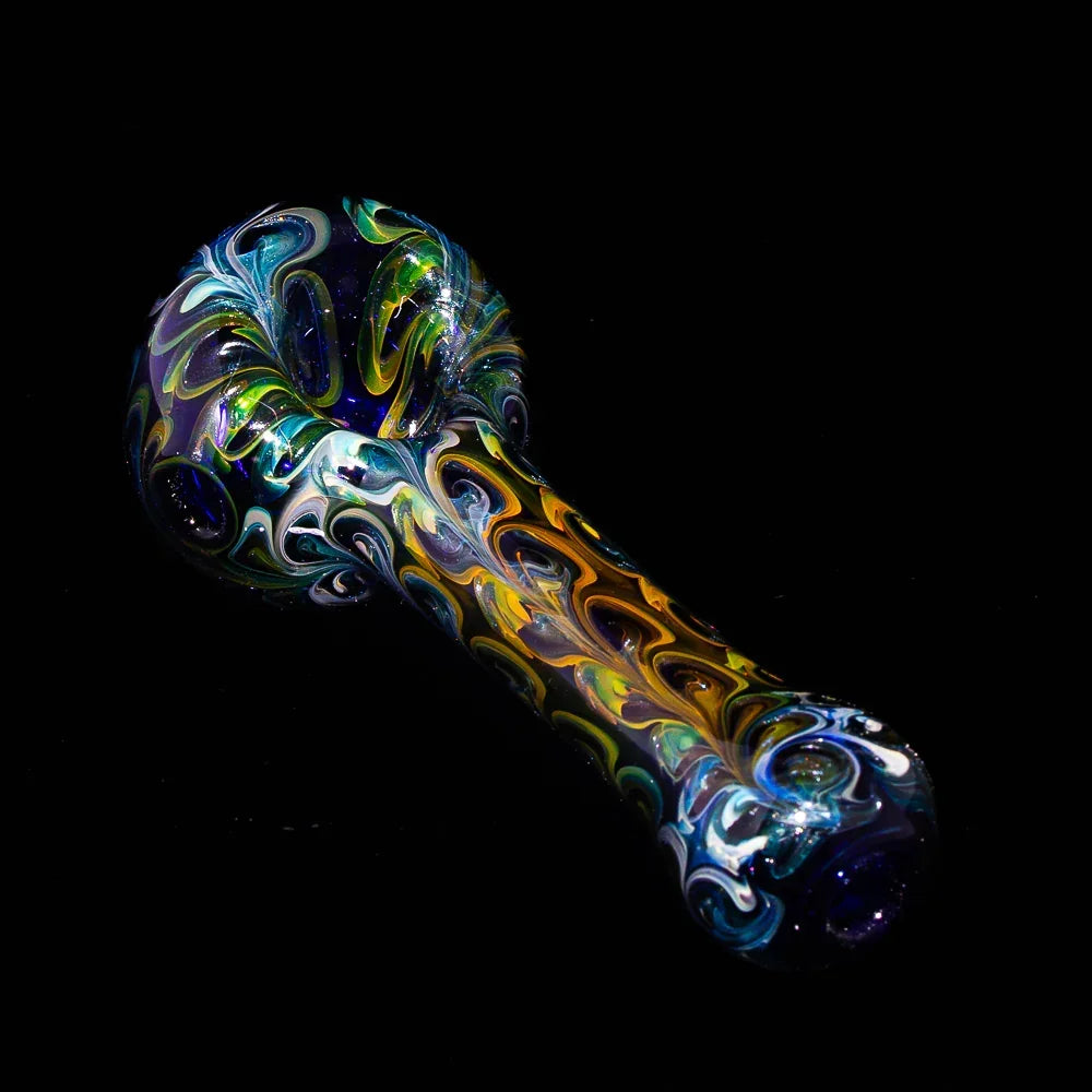 Colorful fumed glass spoon pipe with vibrant paisley swirl patterns on black background