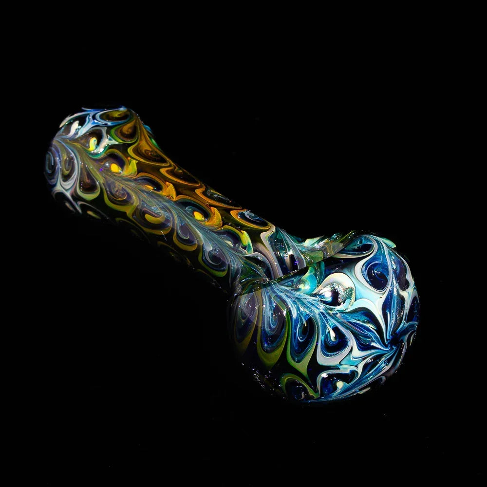 Colorful cobalt fumed paisley glass hand pipe with intricate swirling patterns on black background