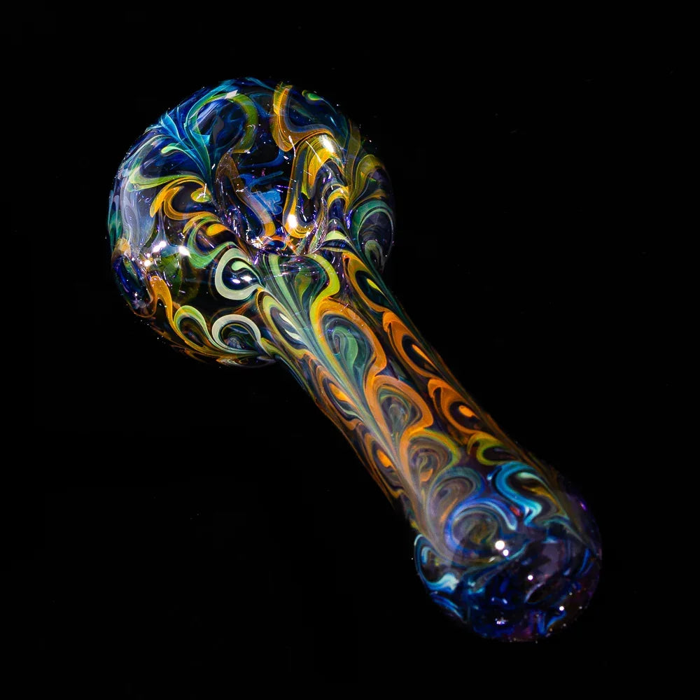 Fumed glass spoon pipe with vibrant blue, green, and orange paisley patterns on black background