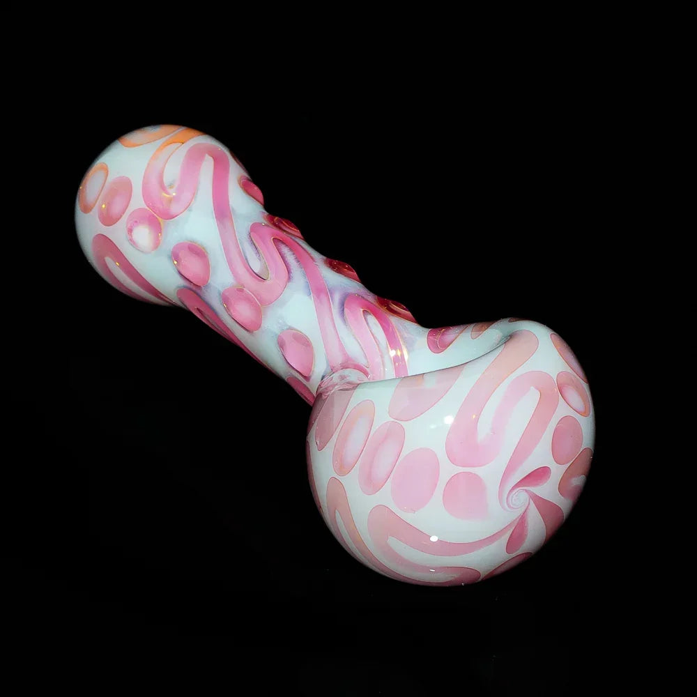 Pink and white glass spoon pipe with swirling patterns on a black background