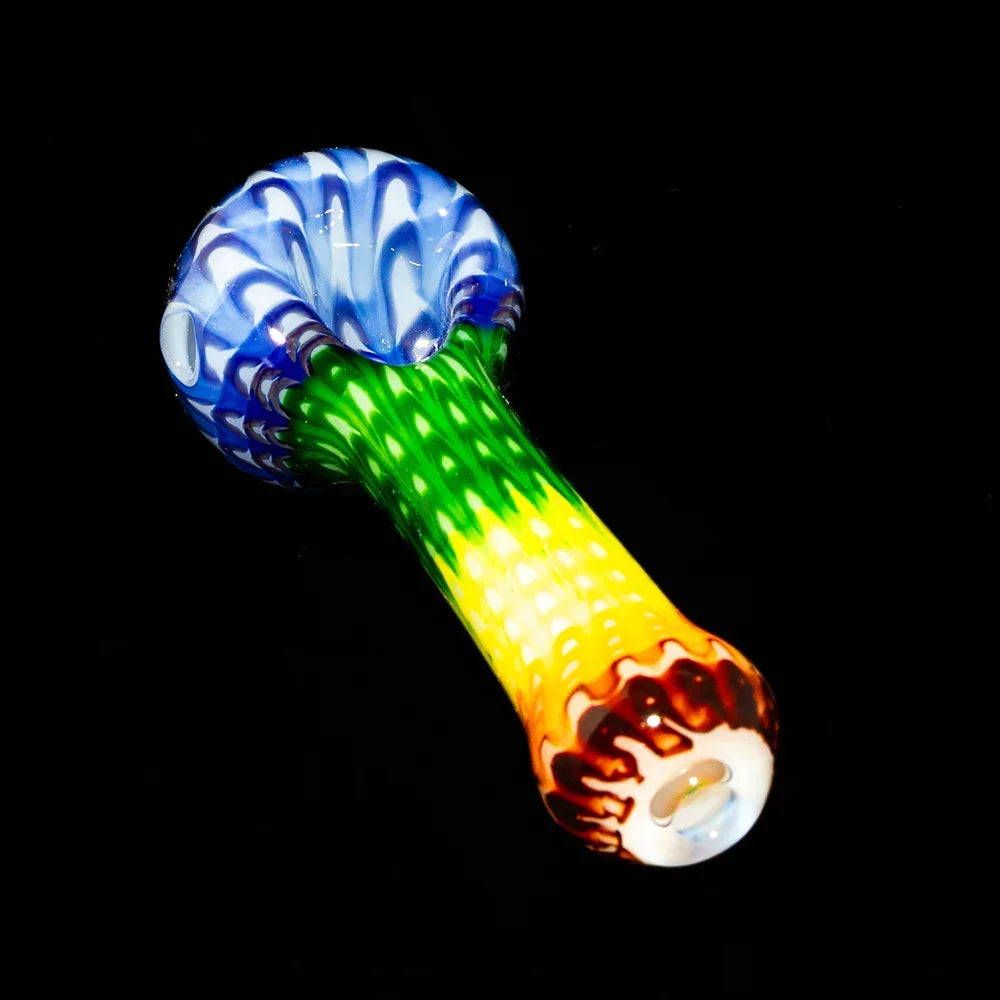 Colorful rainbow glass hand pipe with blue bowl and intricate rake pattern on black background