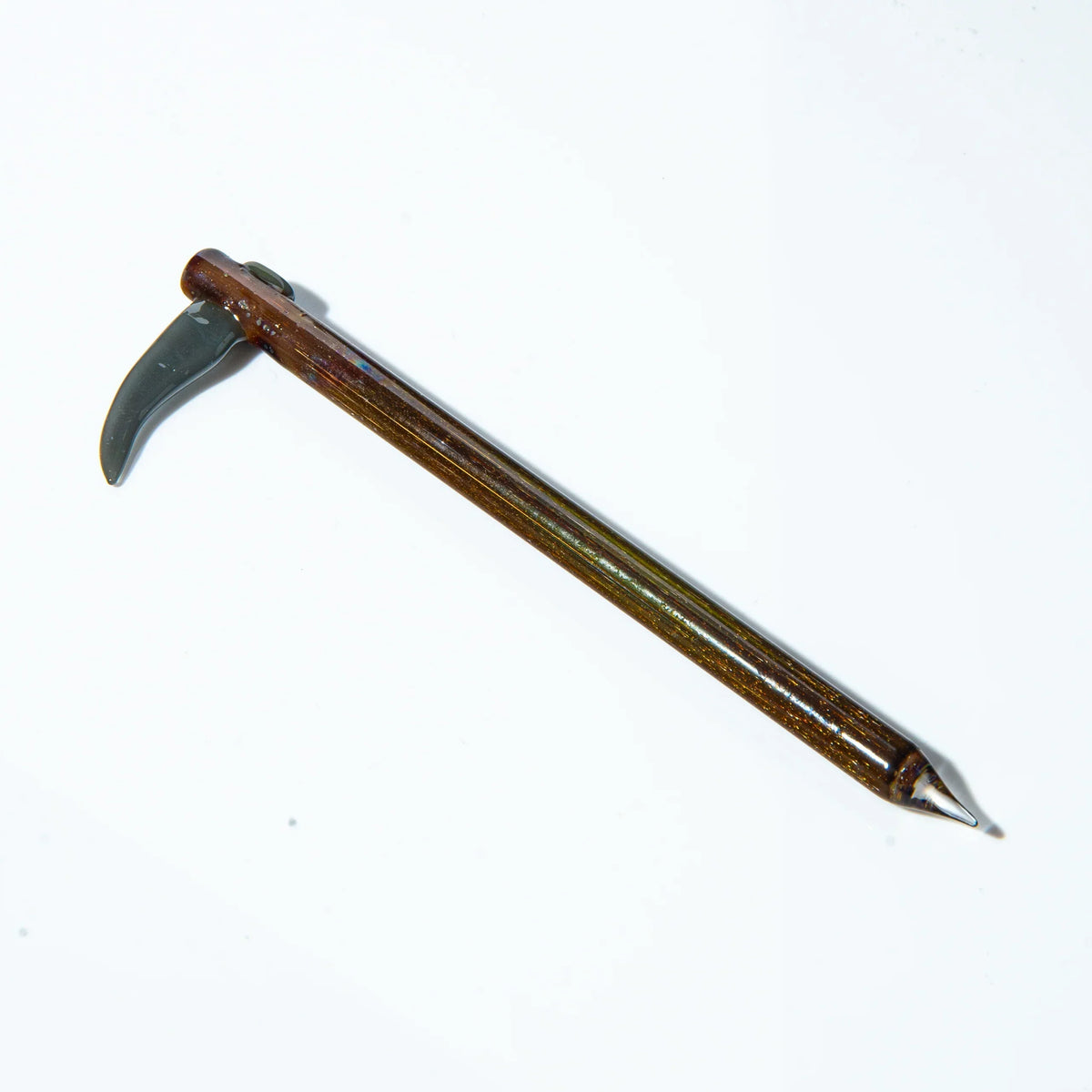 Handcrafted glass scythe dab tool with metallic finish on white background