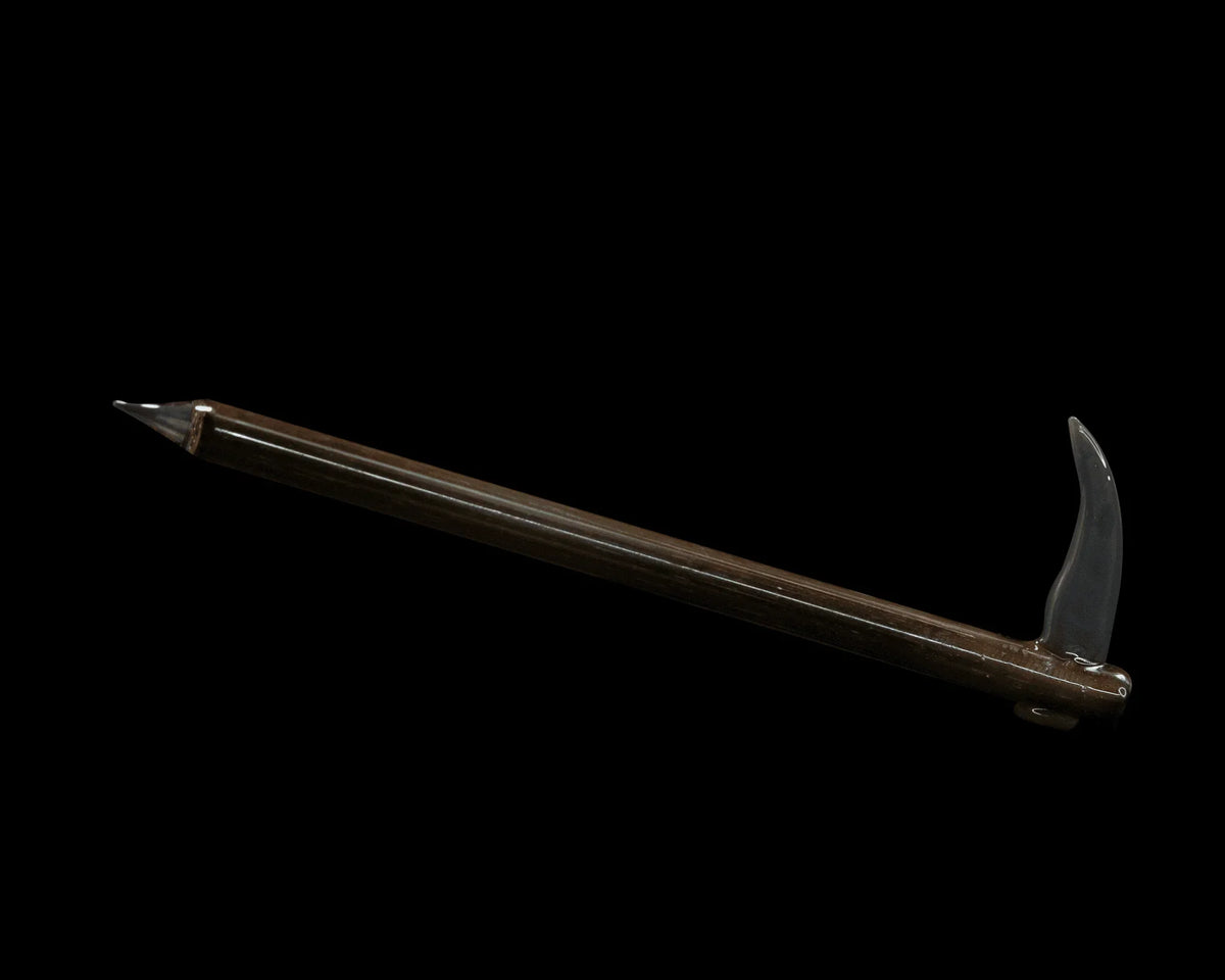 Glass scythe dab tool with brown handle and curved blade on black background