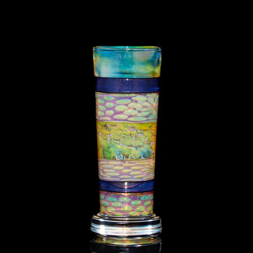 Colorful heady glass cup with intricate patterns on a black background