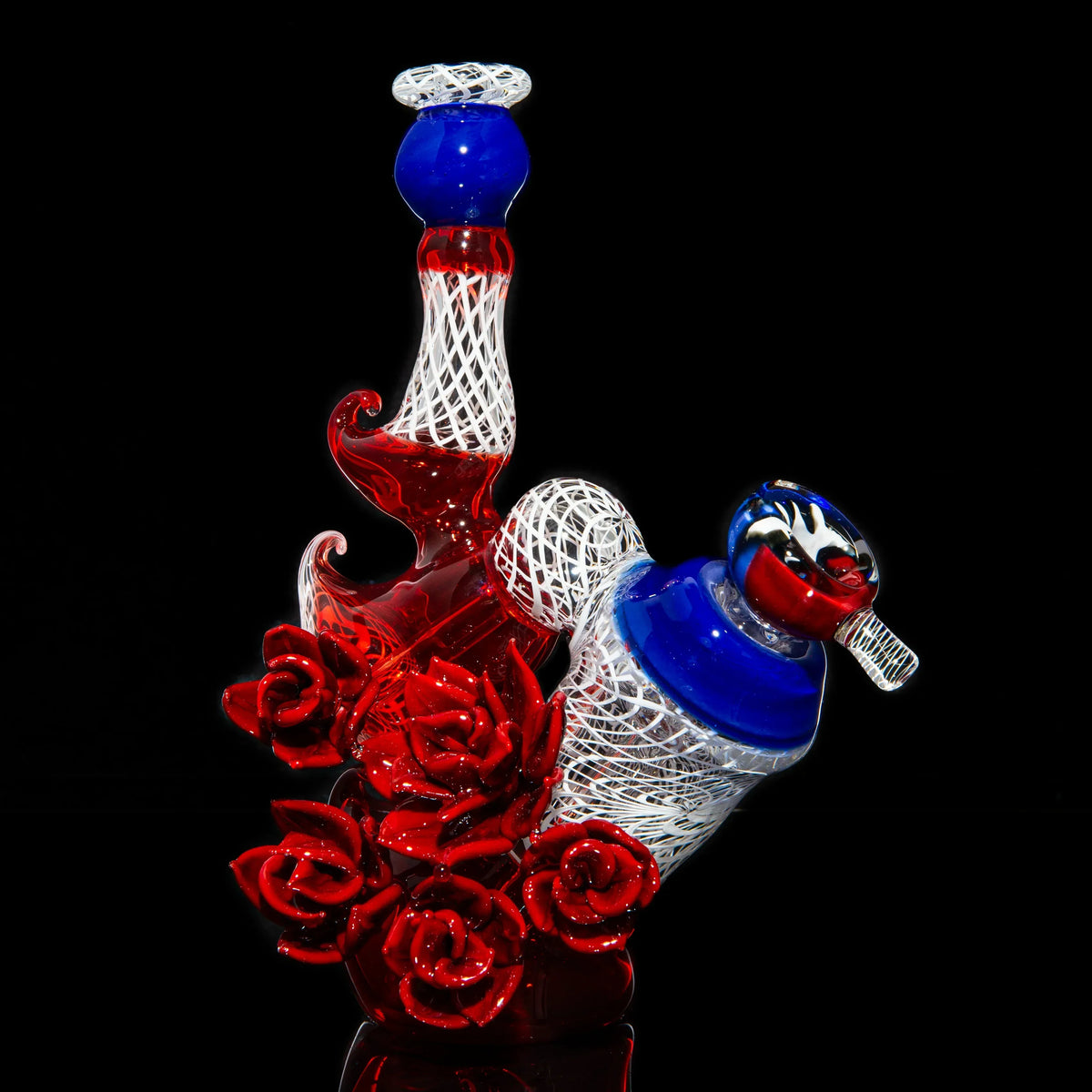 Red, white, and blue glass bubbler with intricate roses and twisted lattice design