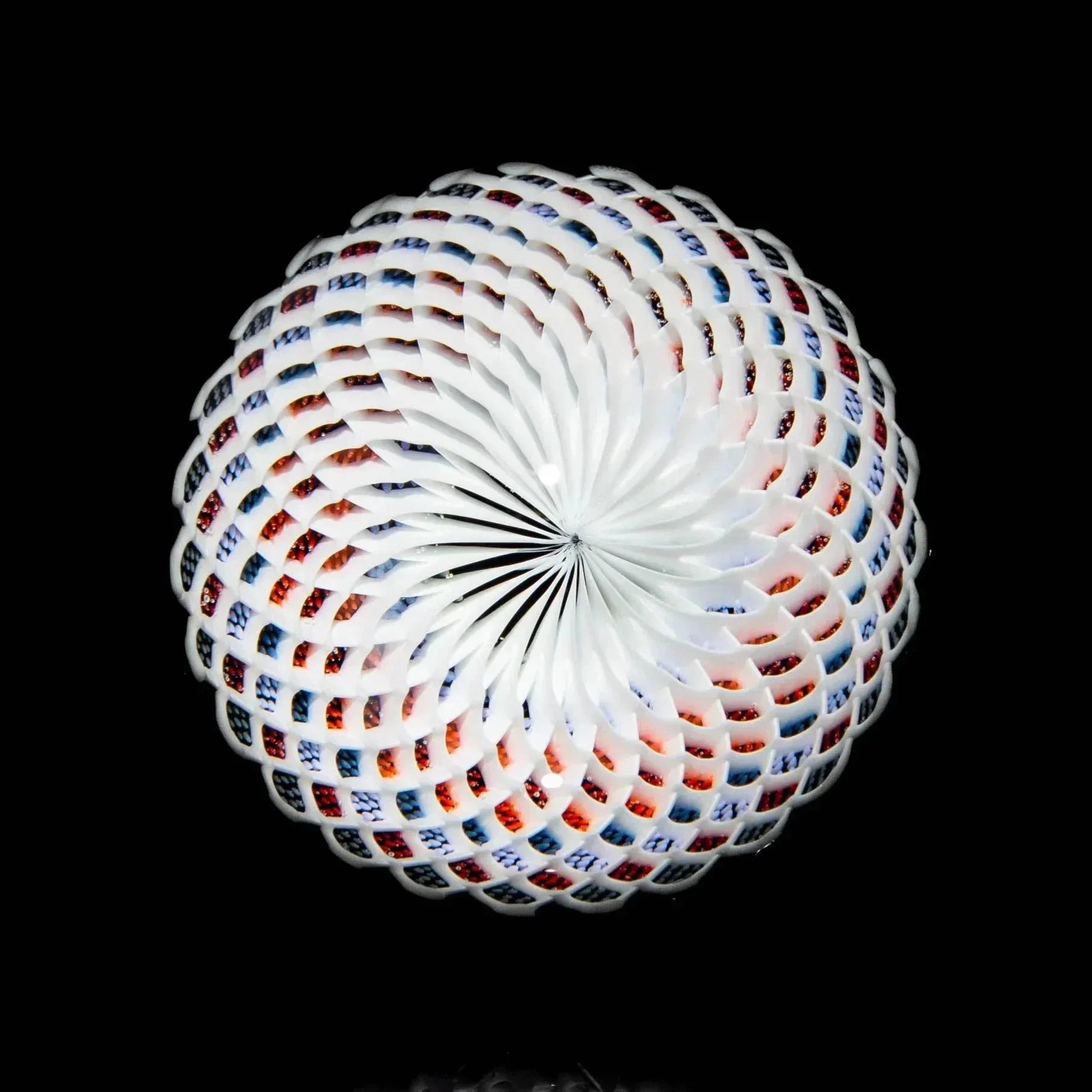 Reticello glass marble with white lattice pattern and colorful accents on black background