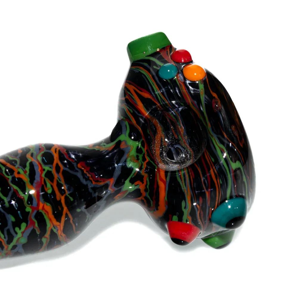 Hand-blown glass spoon pipe with black, orange, and green wig wag design and colored accents