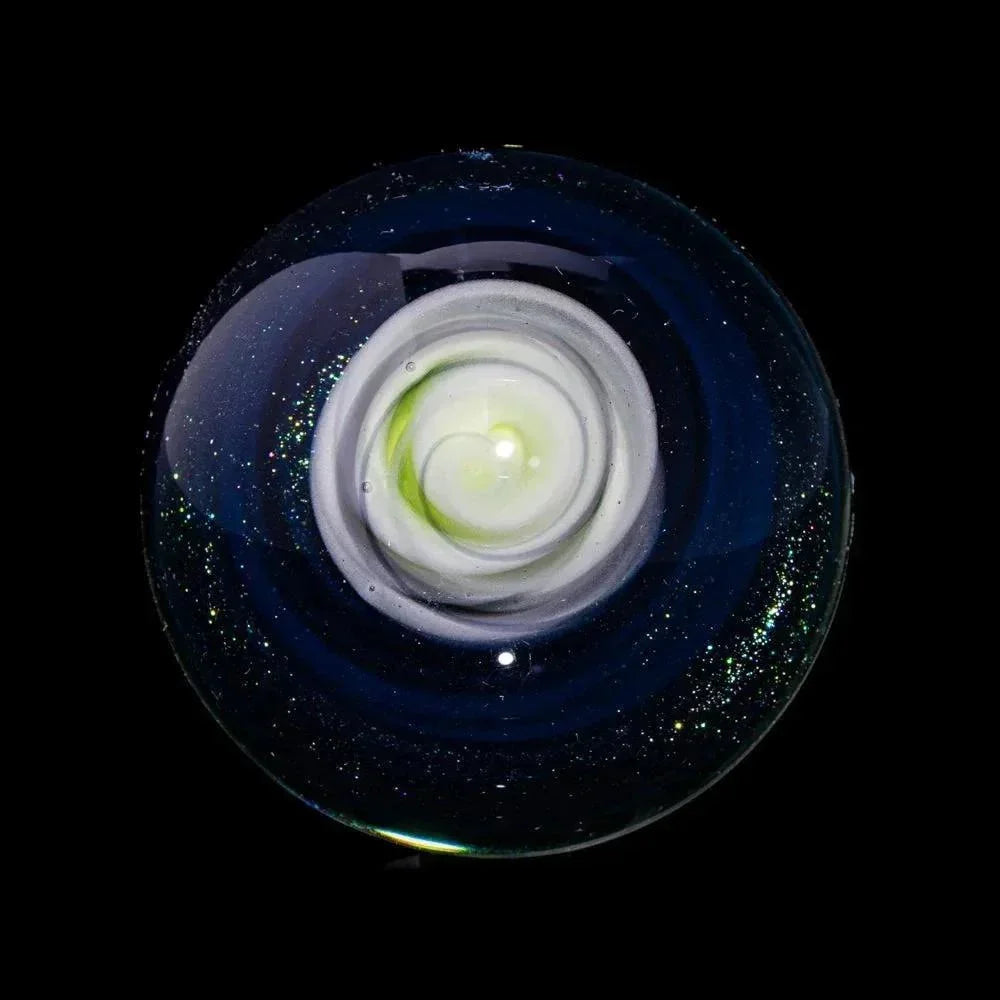 Handcrafted glass marble with spiral white and green core, galaxy-like outer design