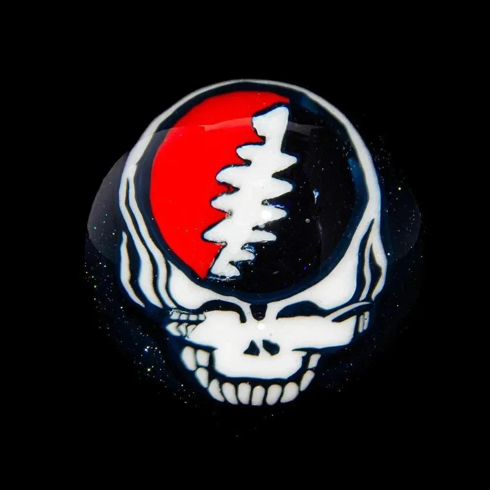 Handcrafted glass marble with a red and white skull design, art glass collectible