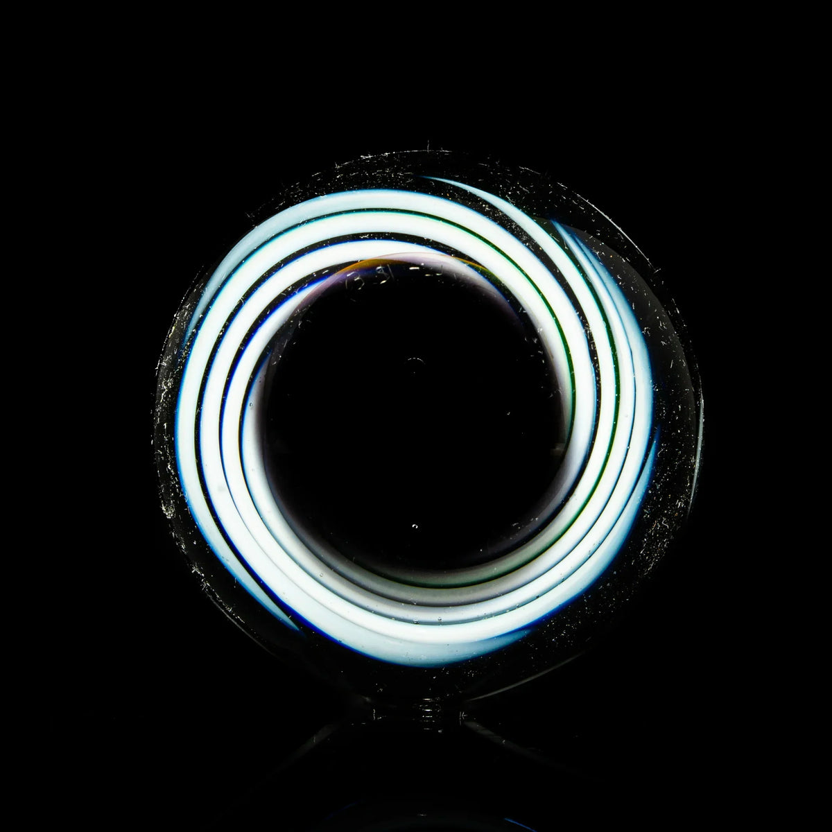 Heady glass marble with glowing spiral design on black background